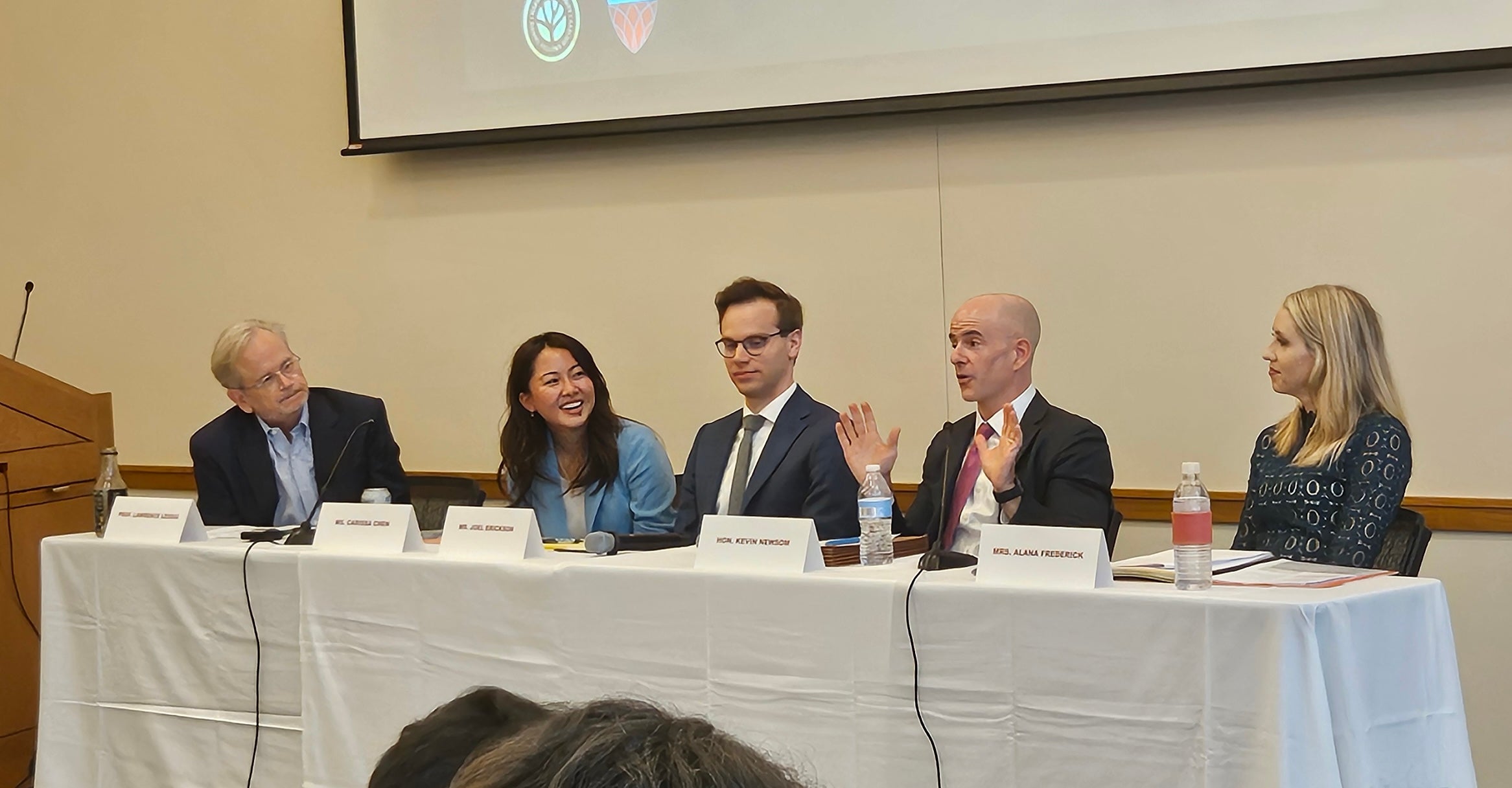 Five people speaking on a panel.