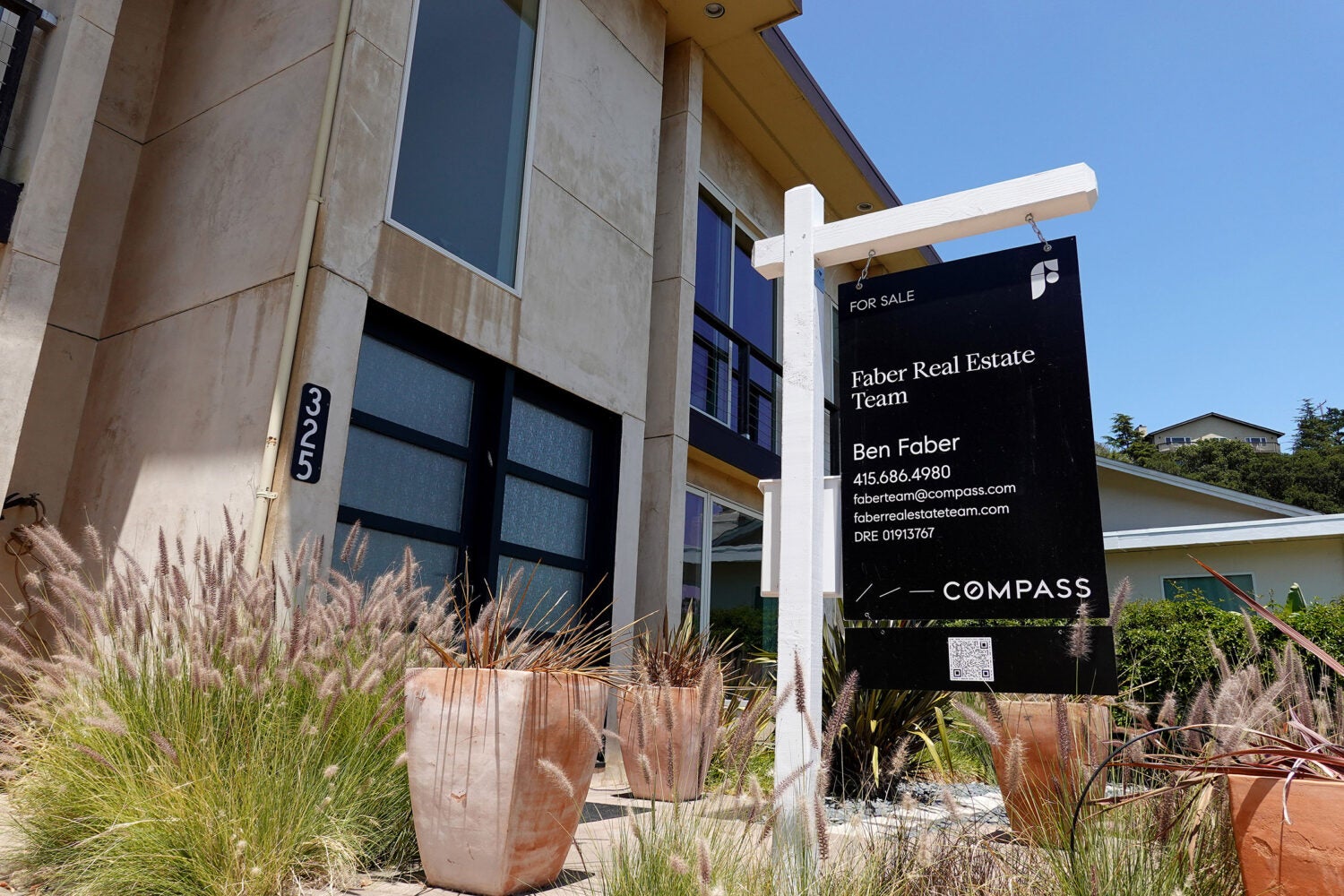 A For Sale sign in front of a home in California.