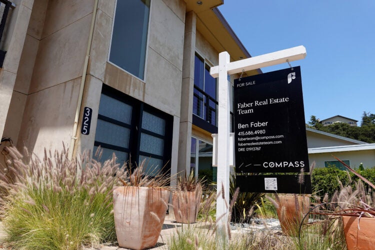 A For Sale sign in front of a home in California.
