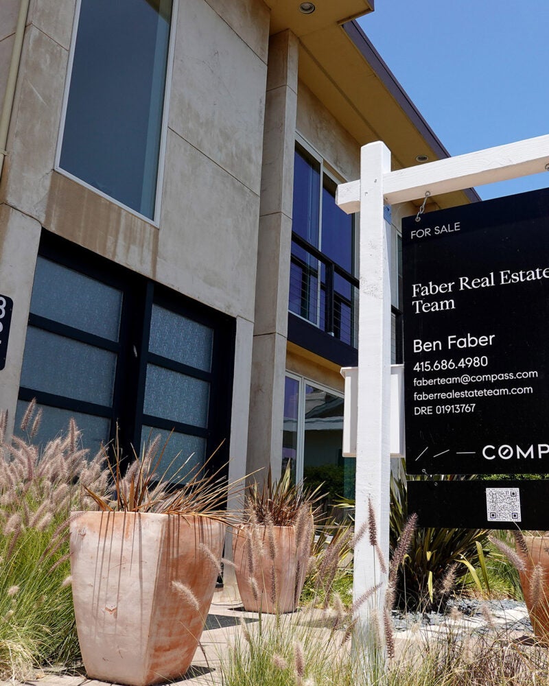 A For Sale sign in front of a home in California.