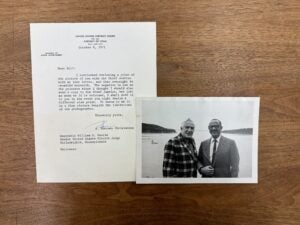 William Hastie and Chief Justice Earl Warren smiling and standing together in front of a large body of water. A typewritten letter accompanying the photograph from A. Sherman Christensen.