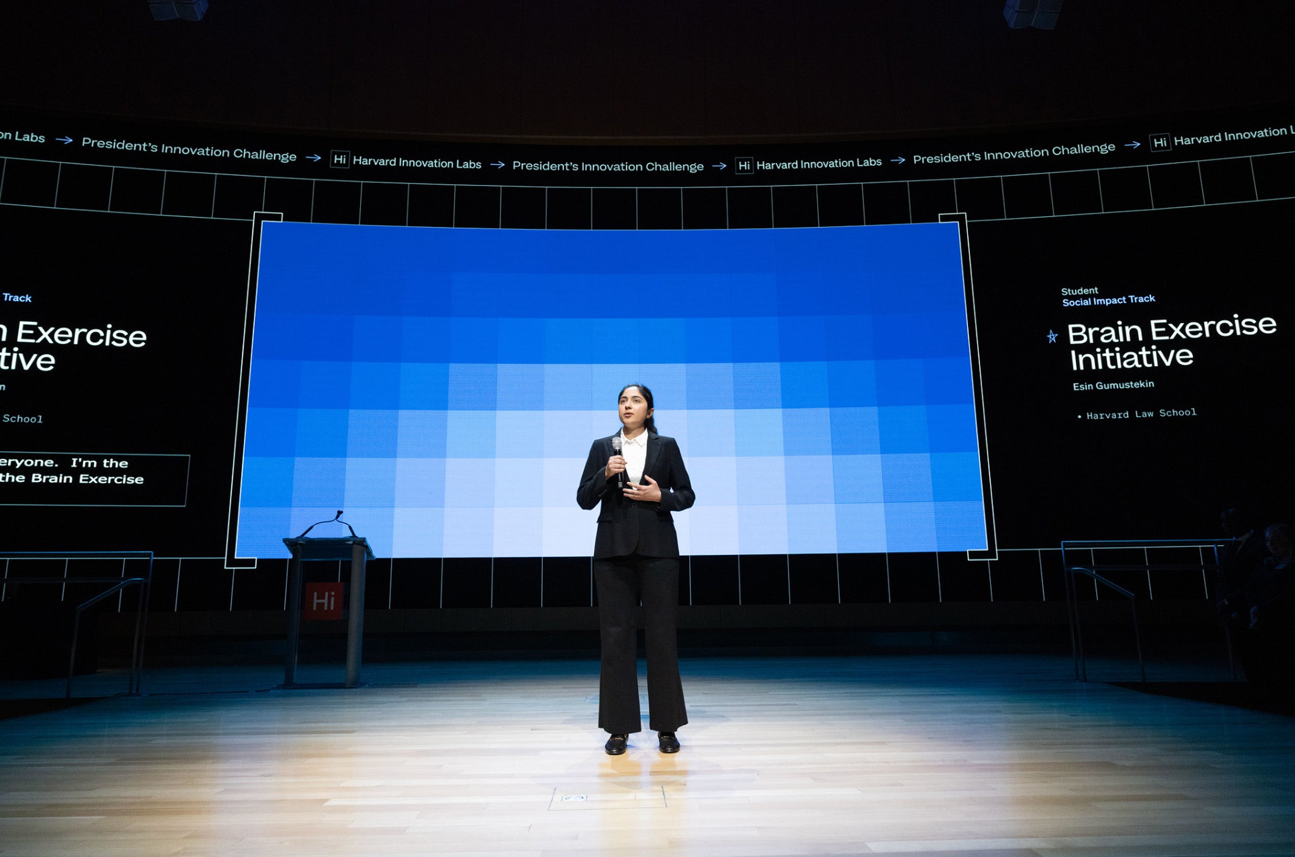 A woman speaking on a large stage.