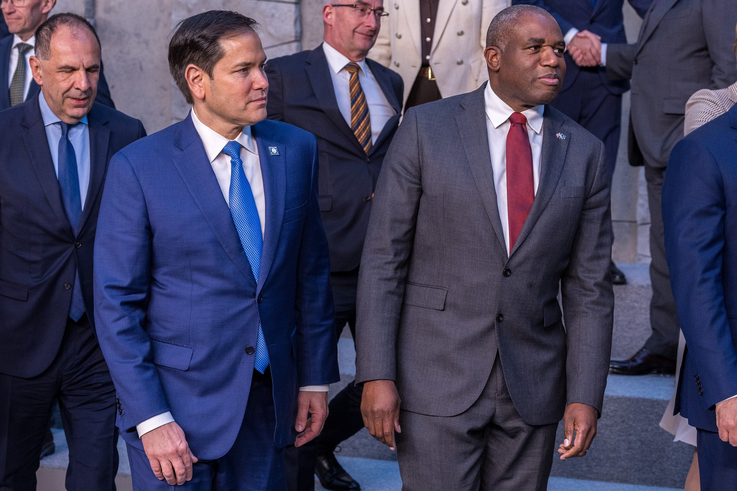 Two men in suits walking.