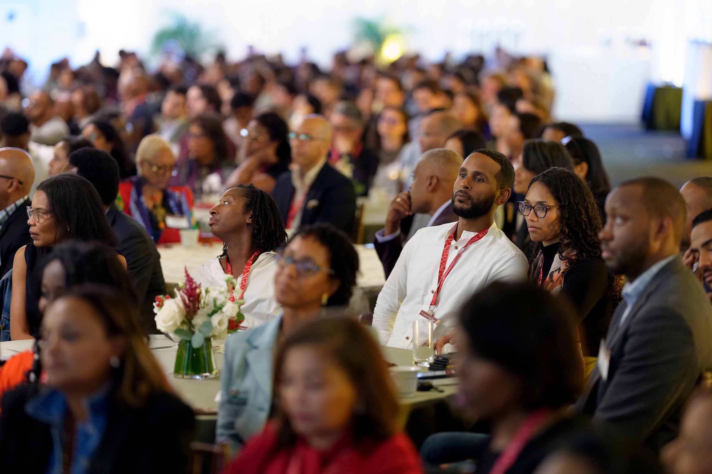 An overview of people sitting at tables at an event.