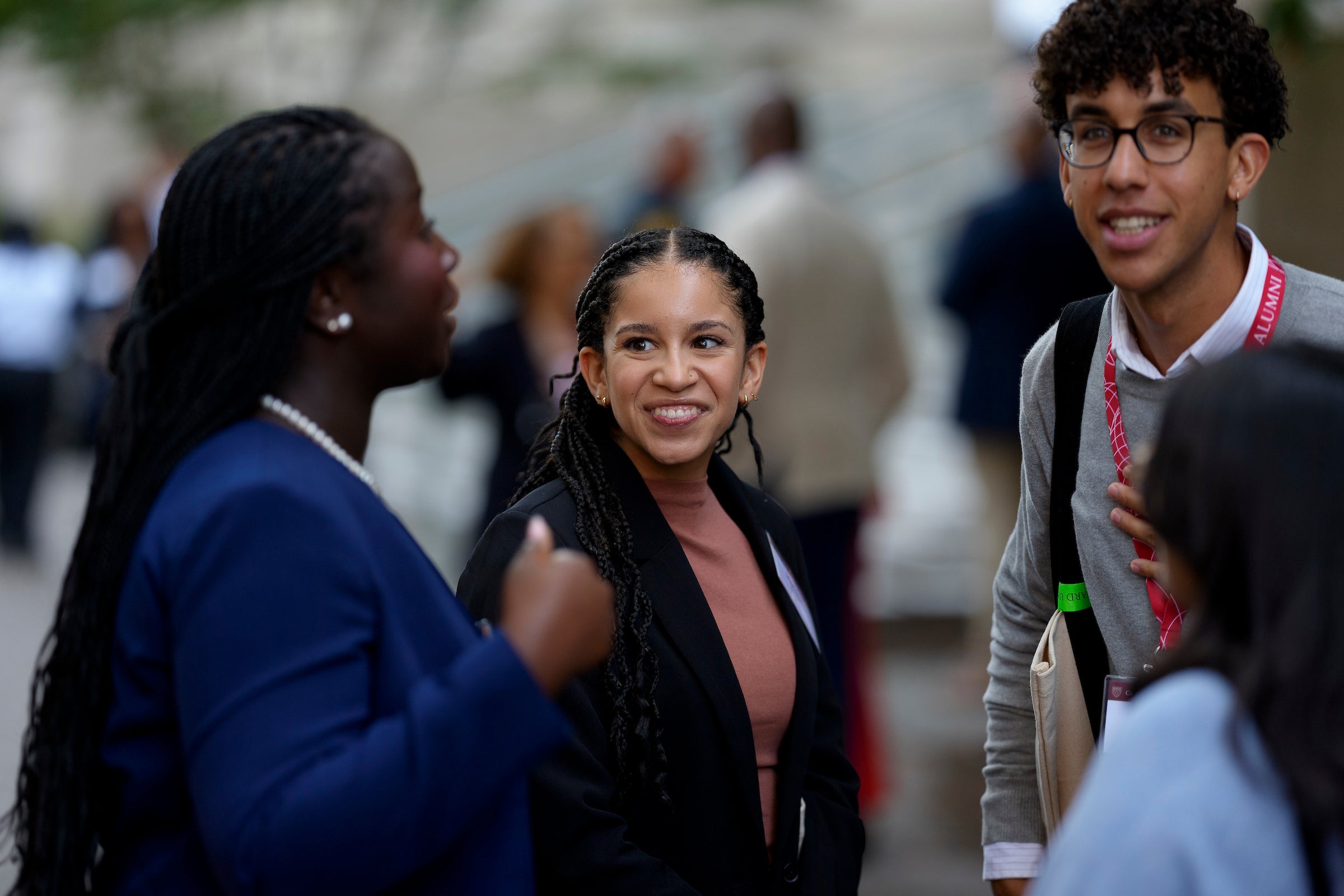 Several students speaking in a hallway at an event.