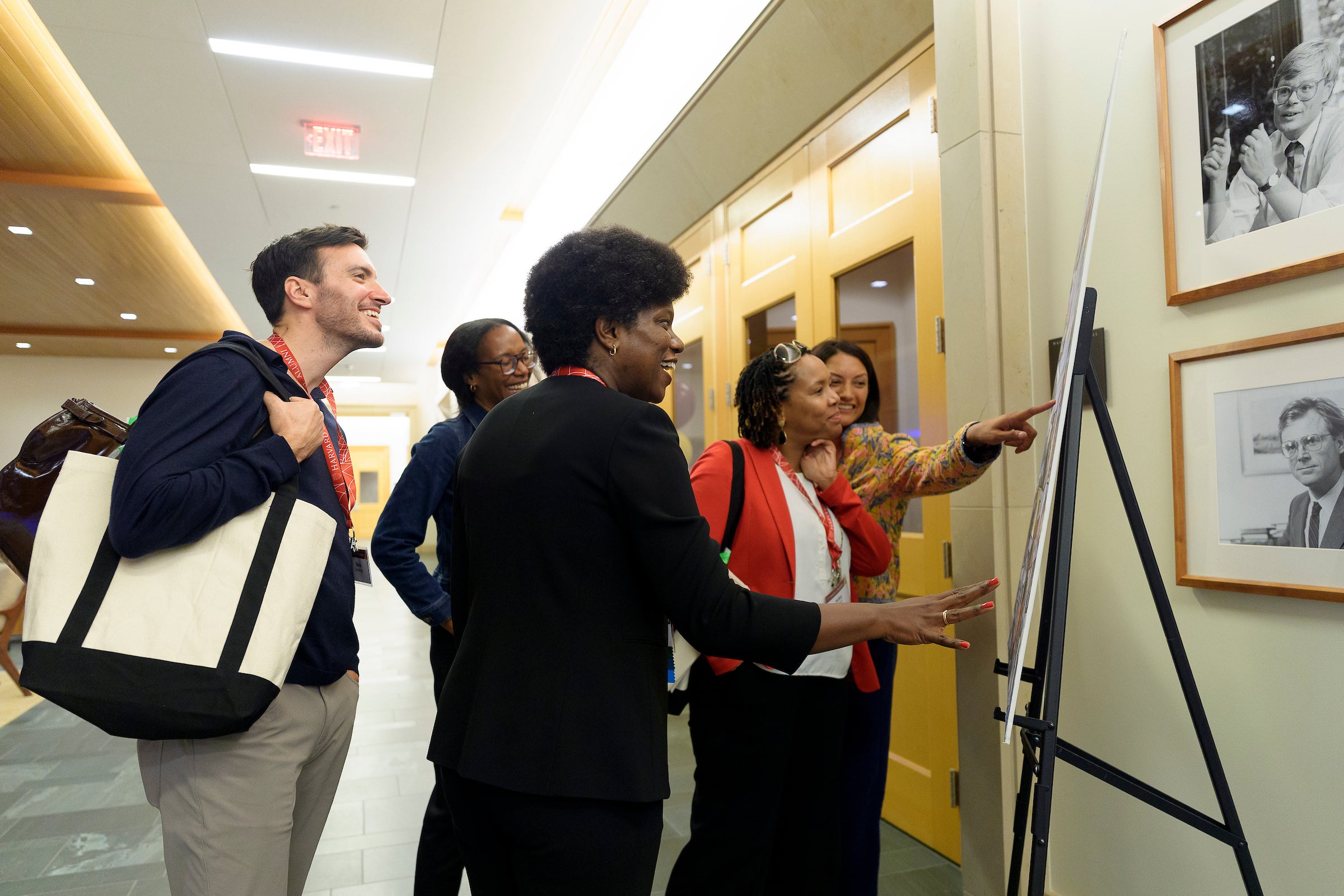 Several people looking at a poster.