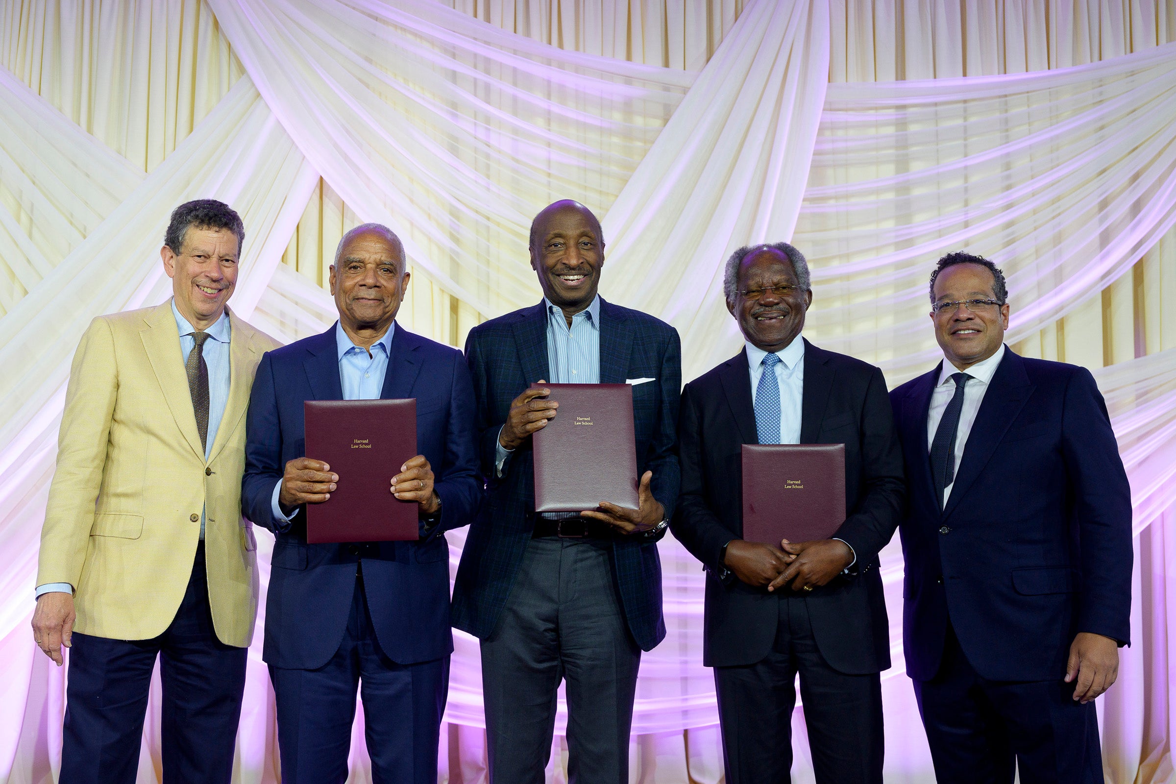 A group of men holding awards at an event.
