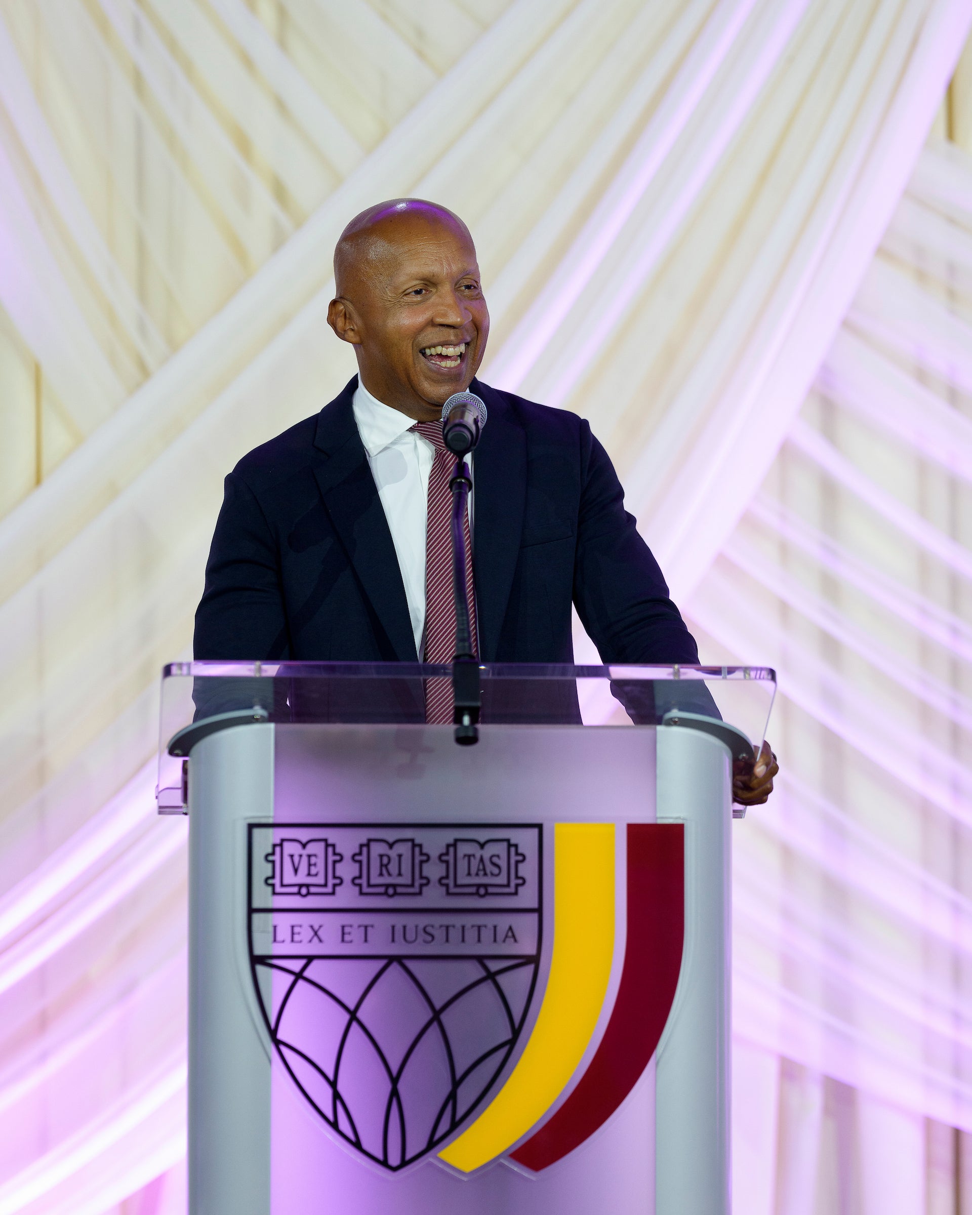 Bryan Stevenson speaking at a podium.