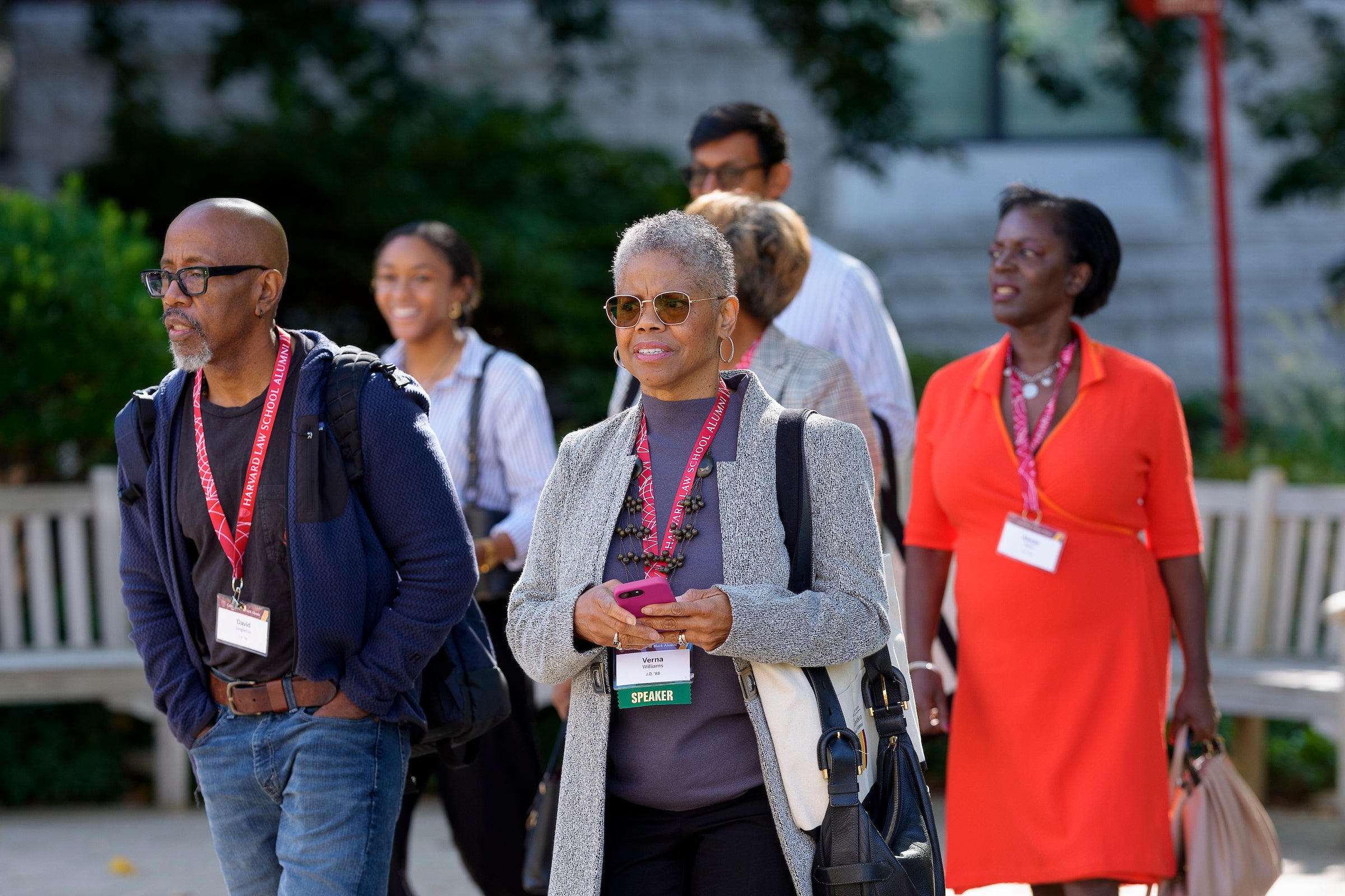 A group of people walk on campus.