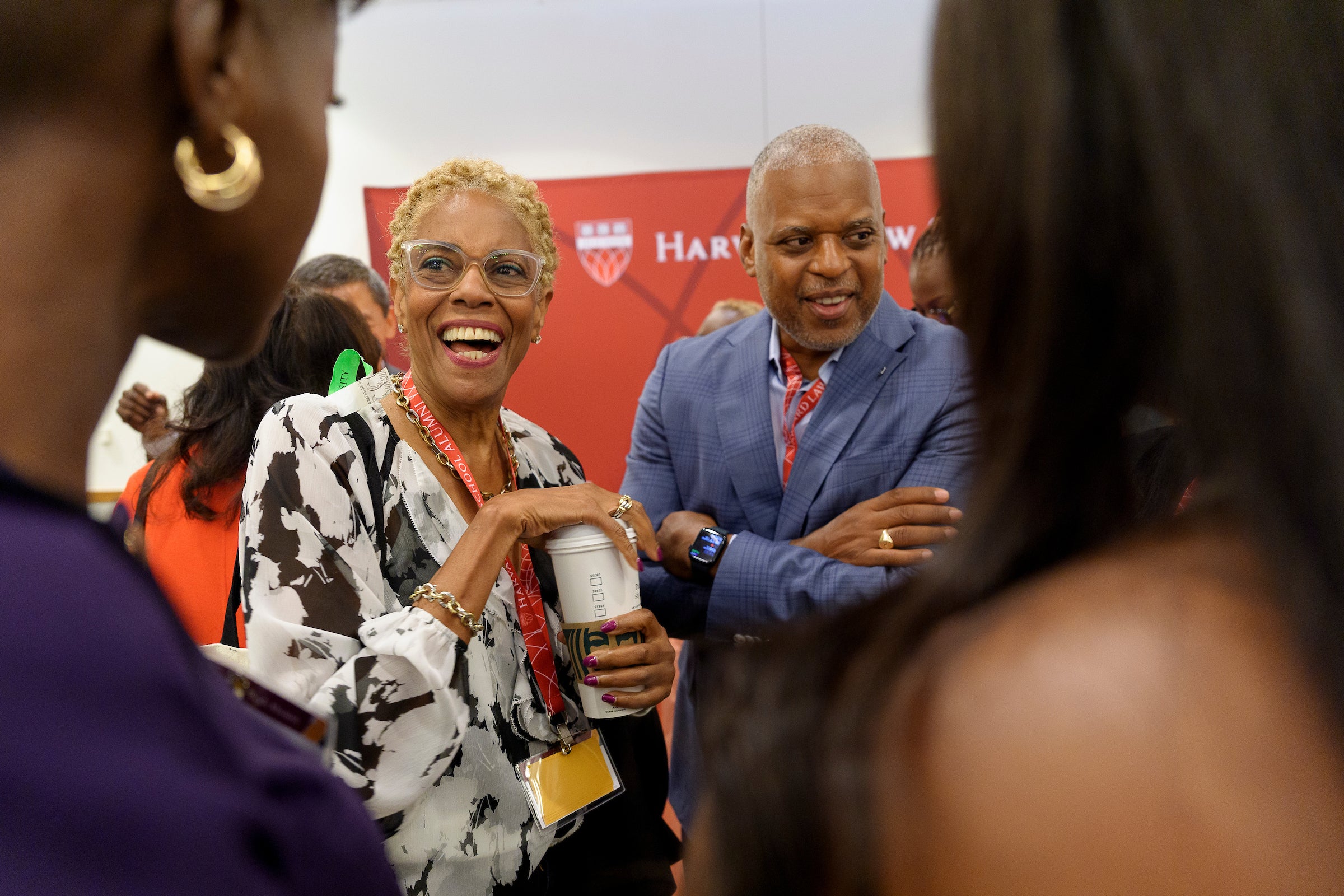A man and a woman enjoying a conversation at an event.