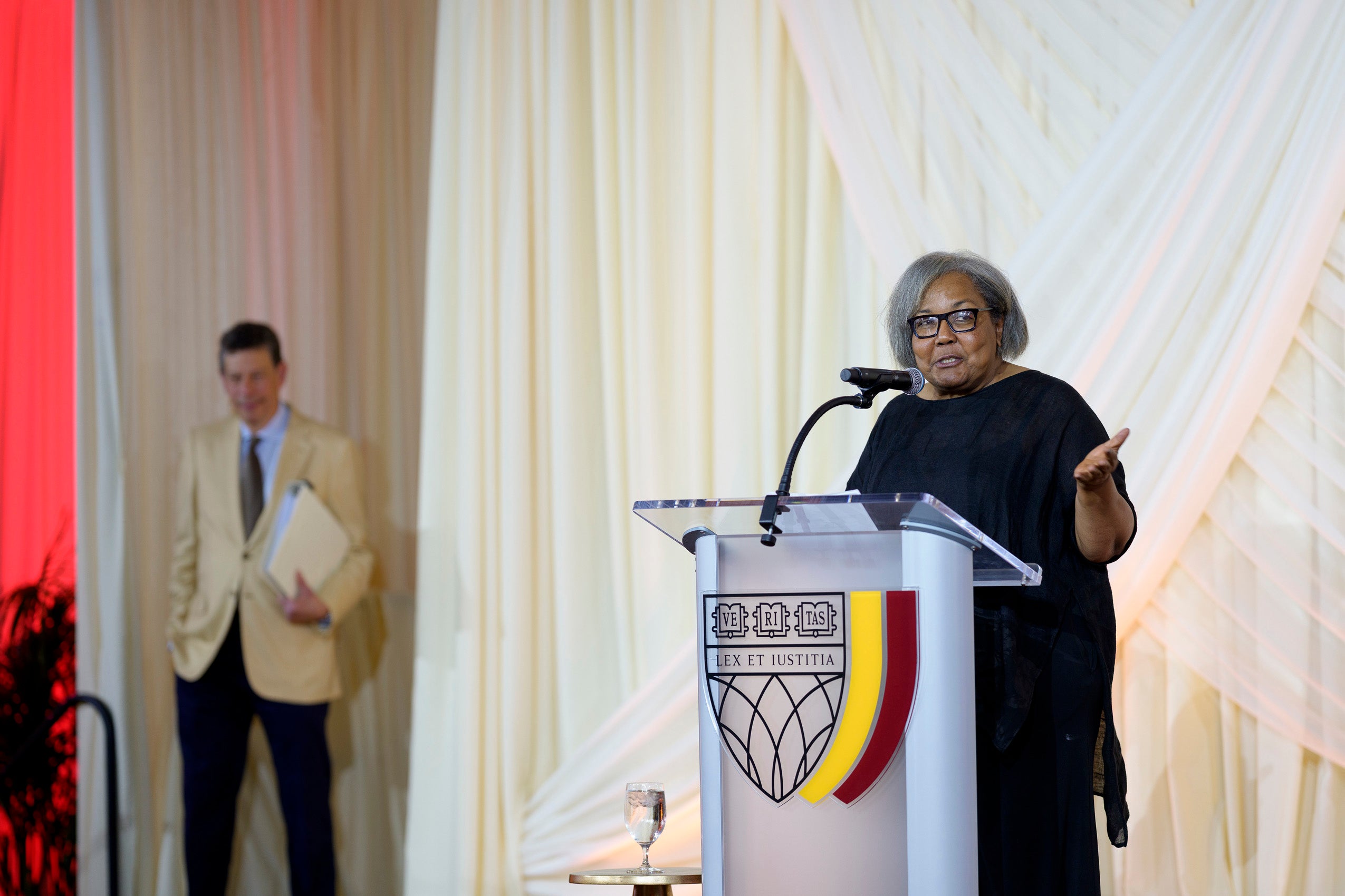 A woman speaking at a podium.