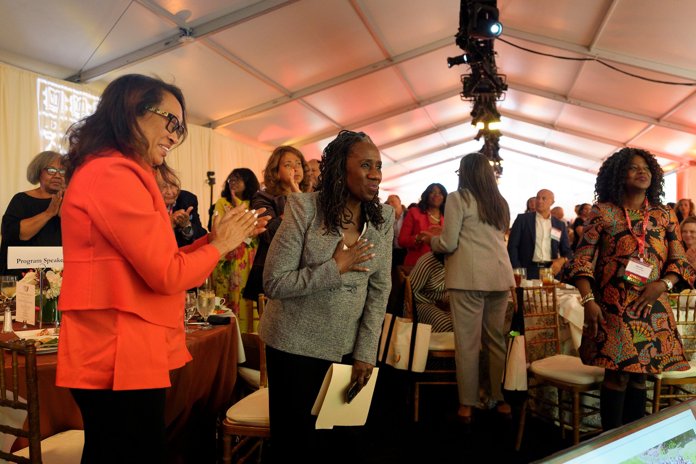 Sherril Ifill gestures thank you from the audience at an event.