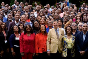 A large group of people pose for a photo at an event.