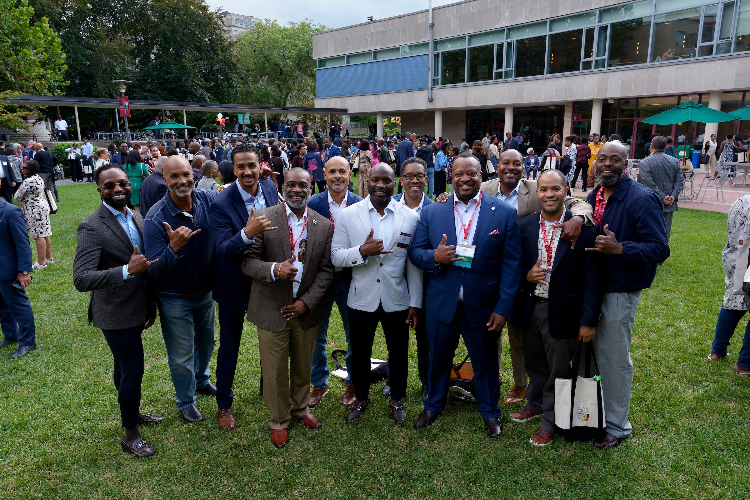 A group of men gather for a group photo on a field.