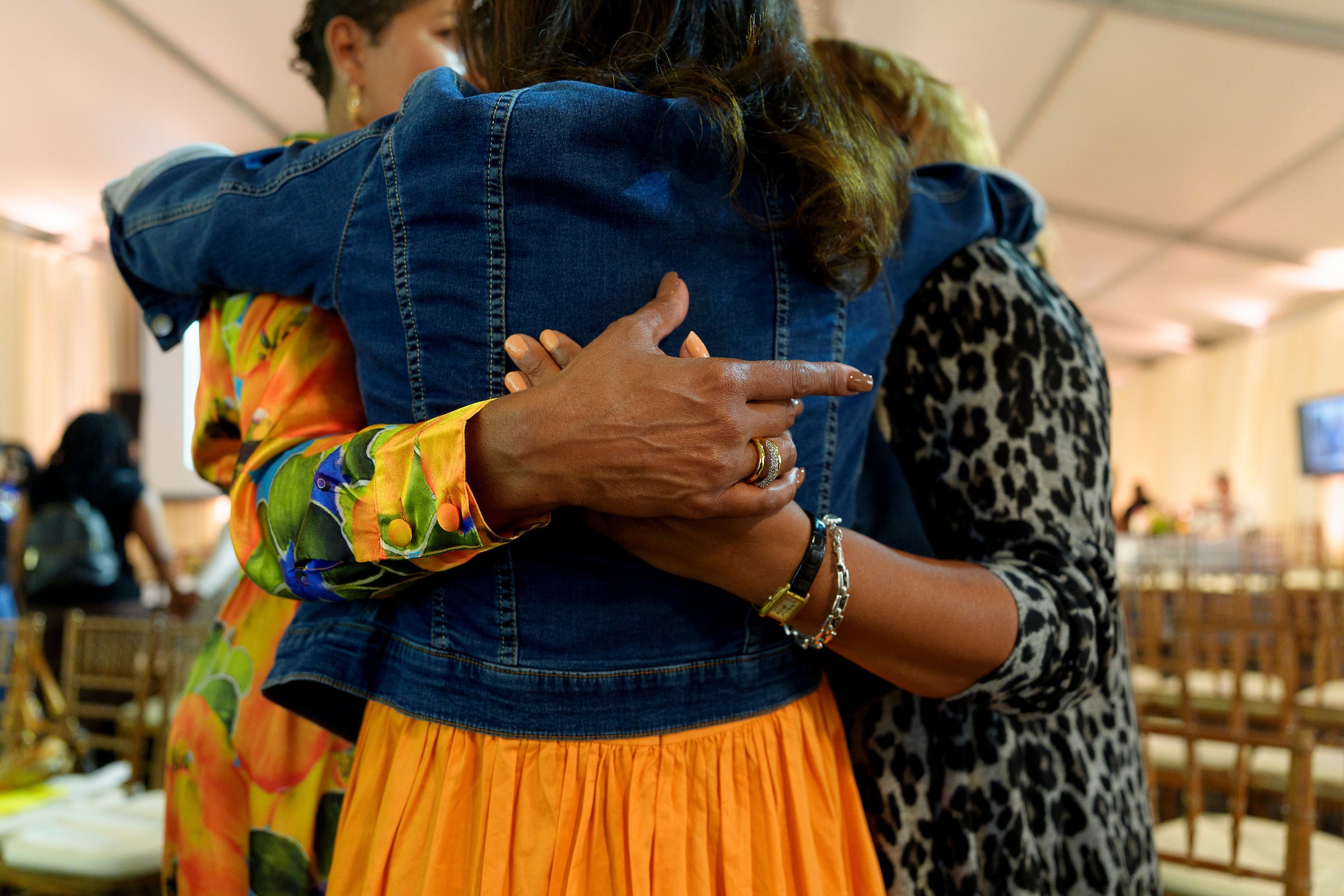 A close up of four people hugging.