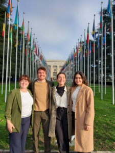 four people stand outside the UN in Geneva