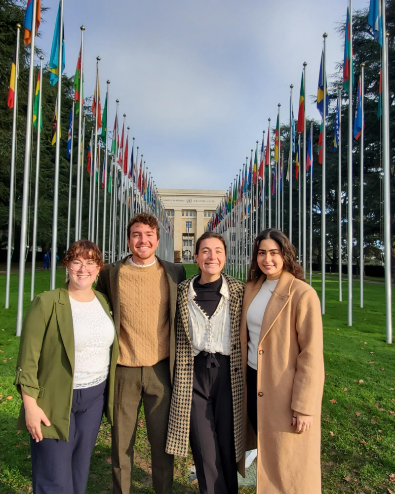 four people stand outside the UN in Geneva