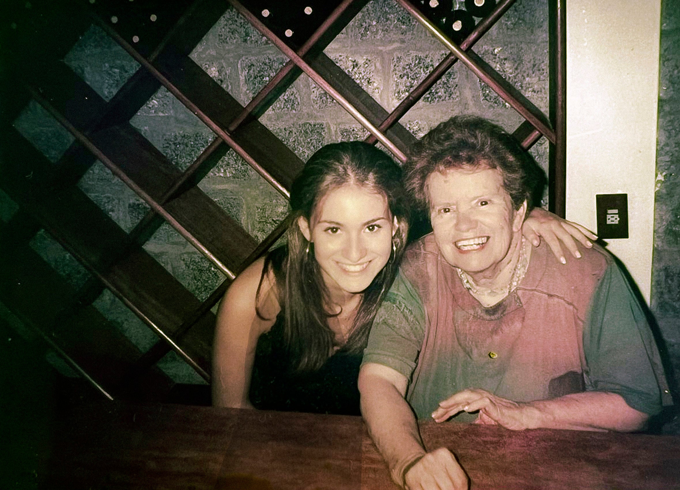 A candid shot of a young woman and an older woman smiling.
