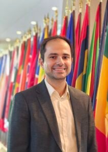 Person standing in front of flags