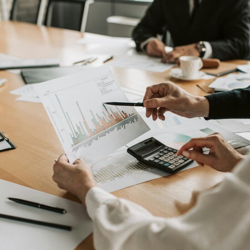 Board meeting where people look at charts.