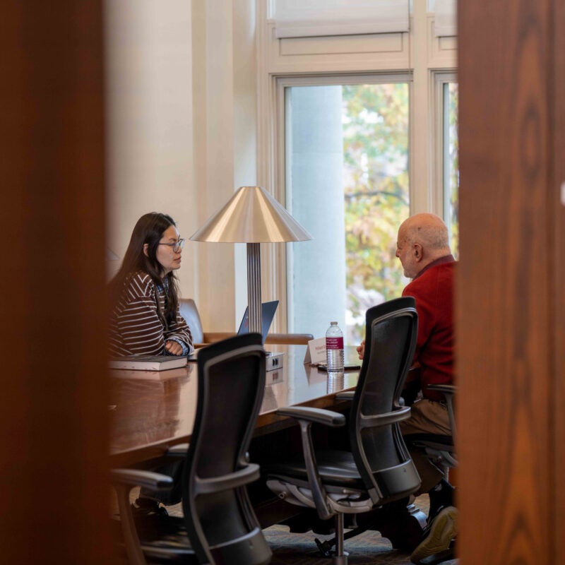 Joseph Singer meeting with a student.