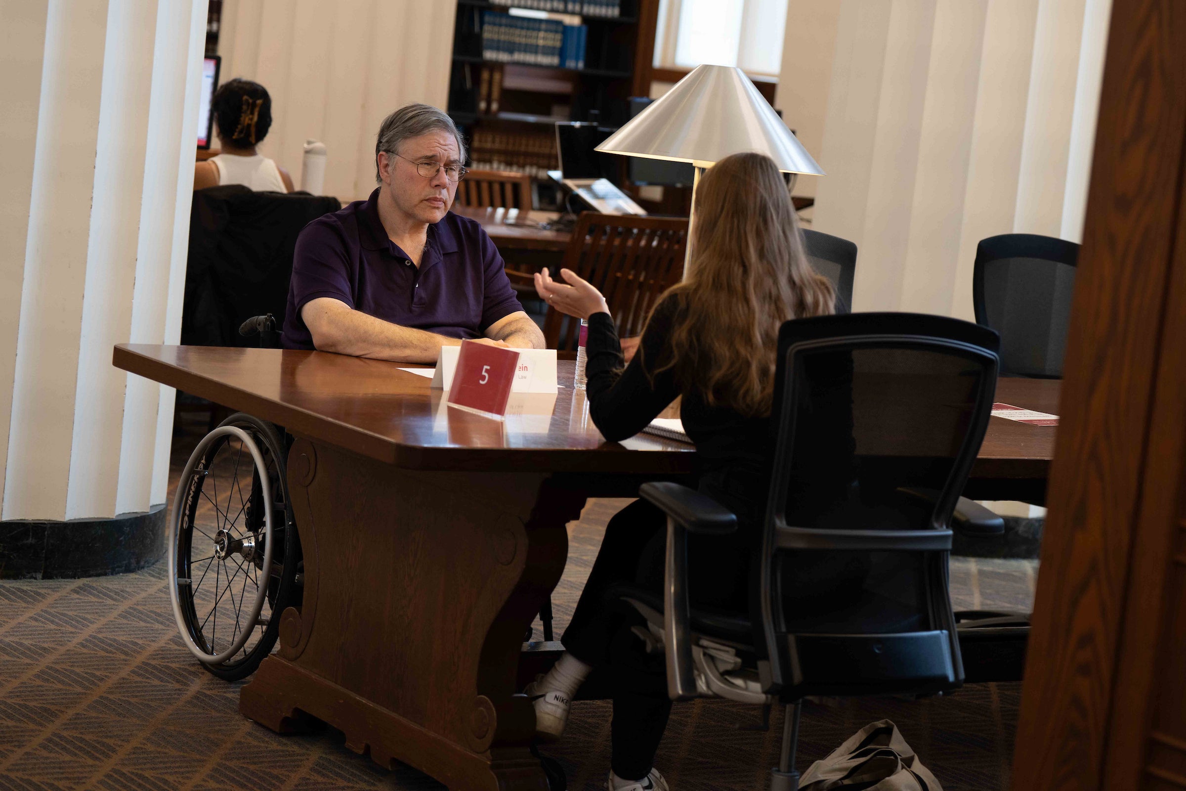 Michael Ashley Stein speaks with a student.