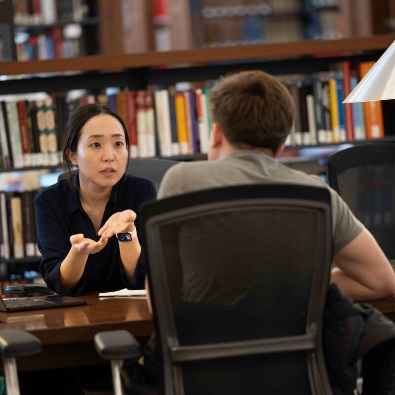 A student and faculty member engage.