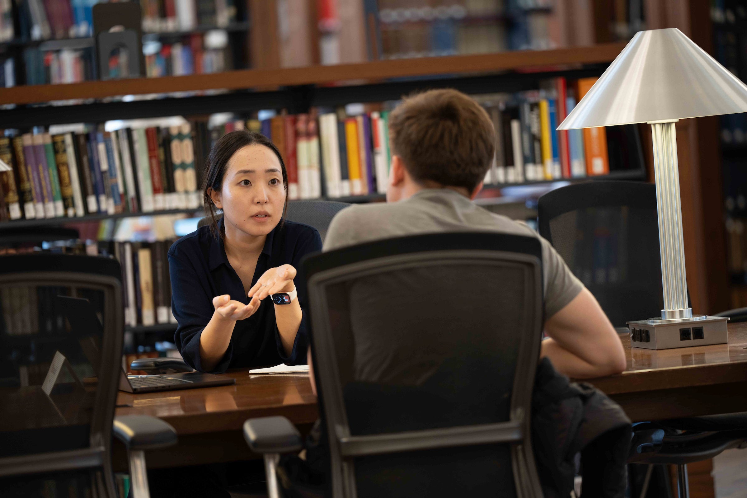 A student and faculty member engage.