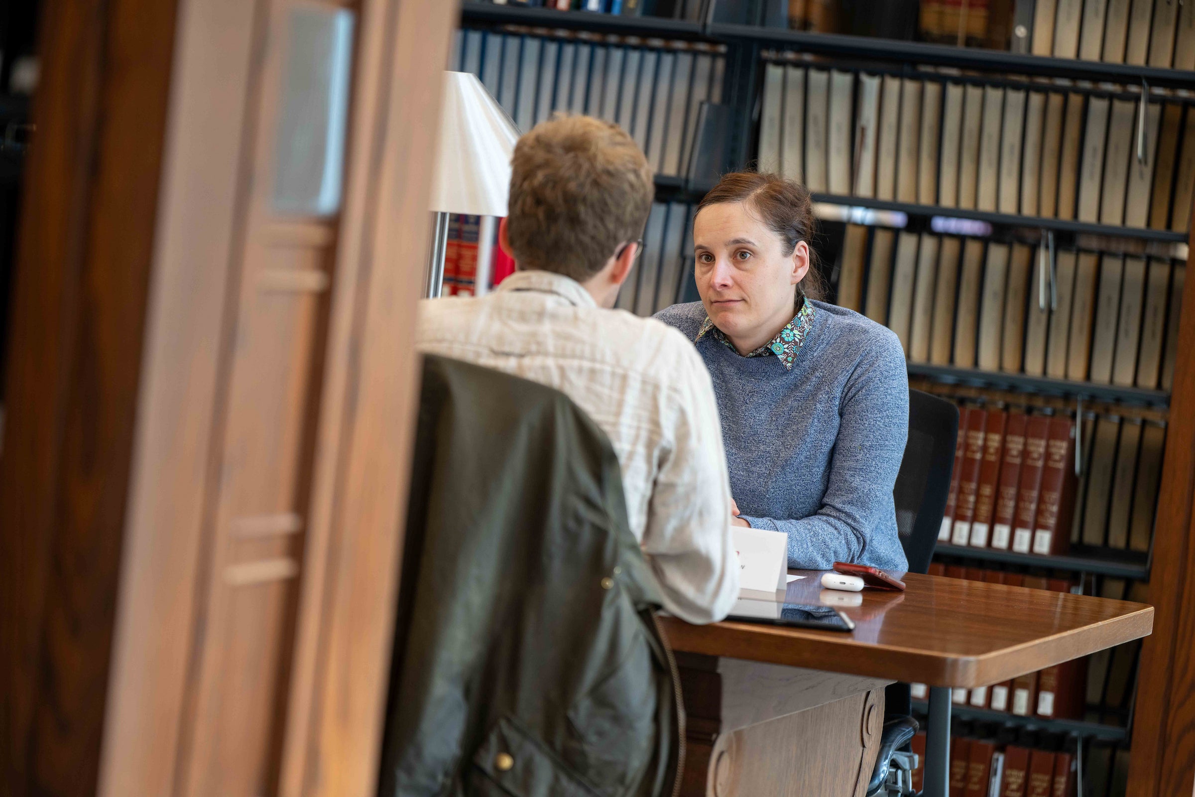 A faculty member and student talk.