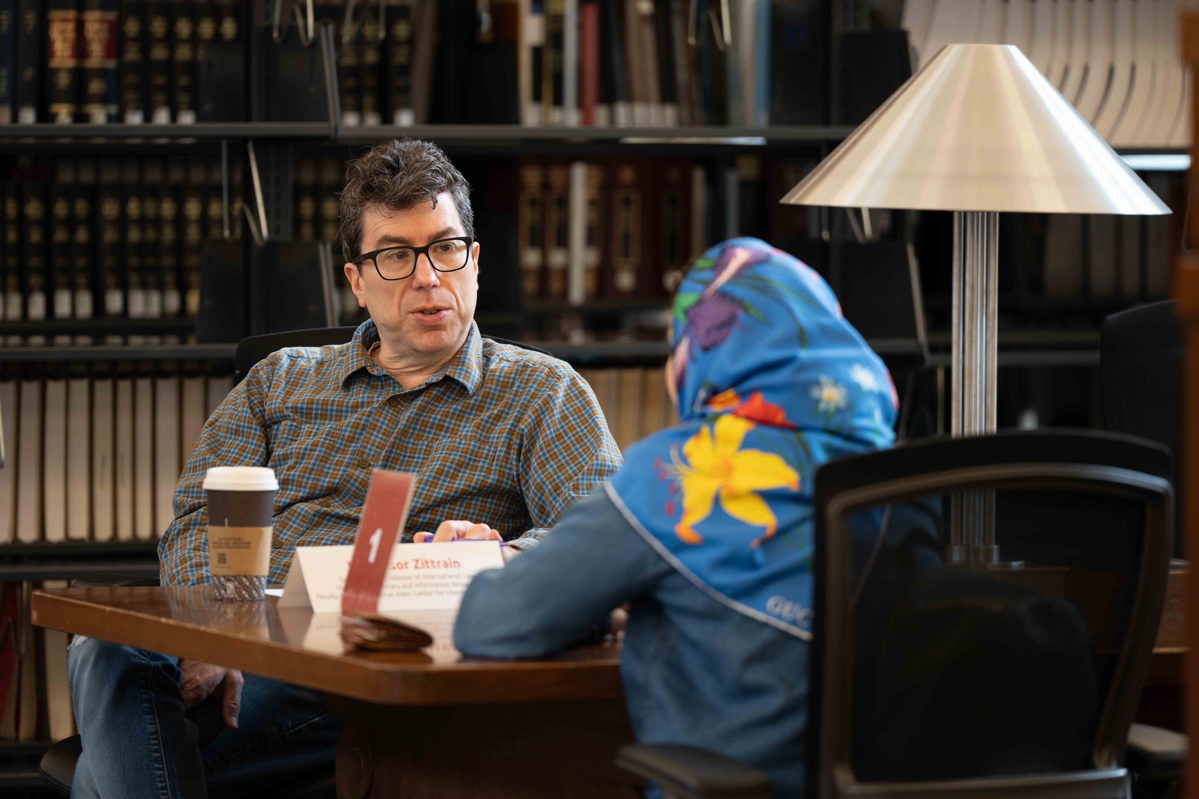 Jonathan Zittrain talks with a student.