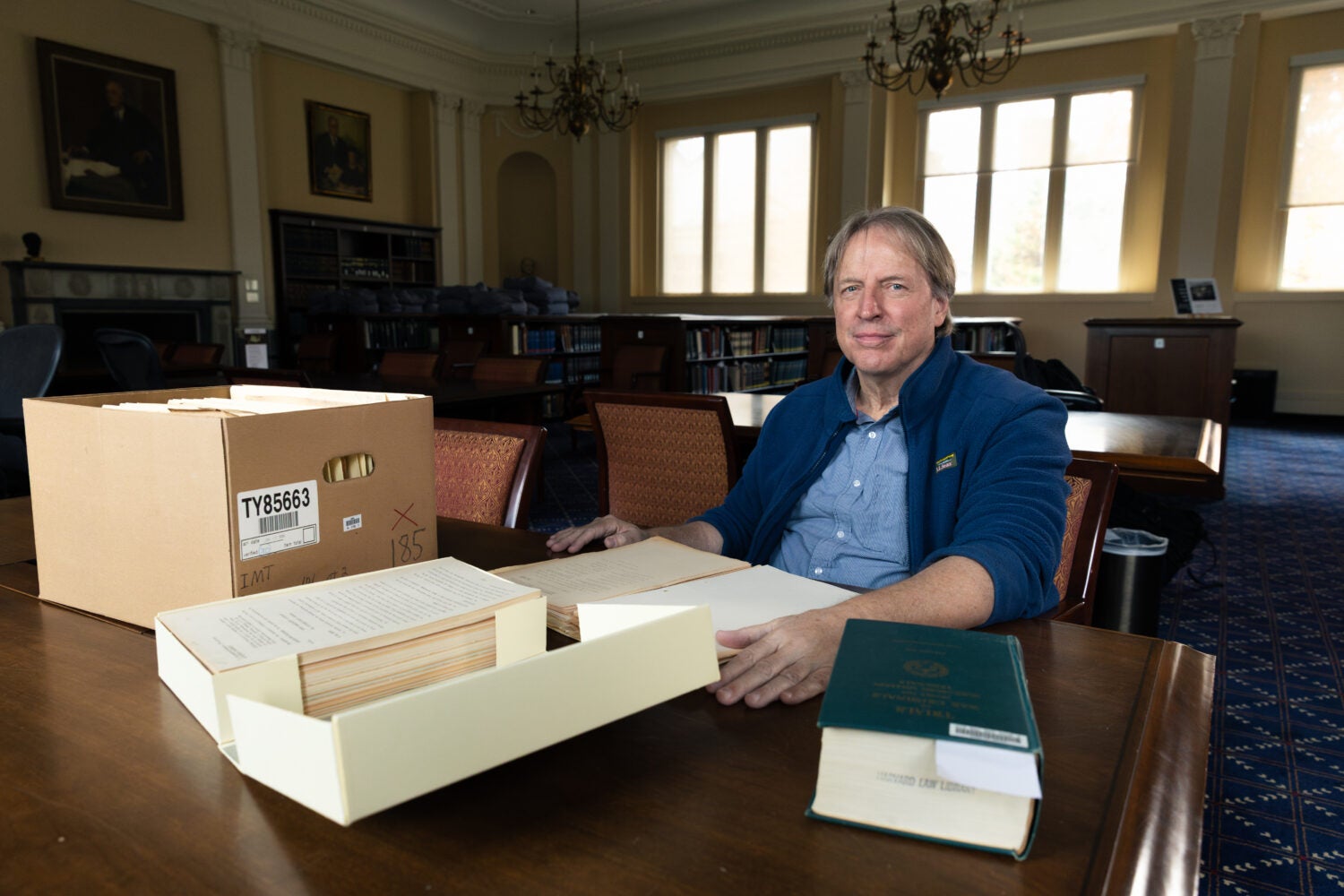 Paul Deschner at a table with Nuremberg files.