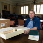 Paul Deschner at a table with Nuremberg files.