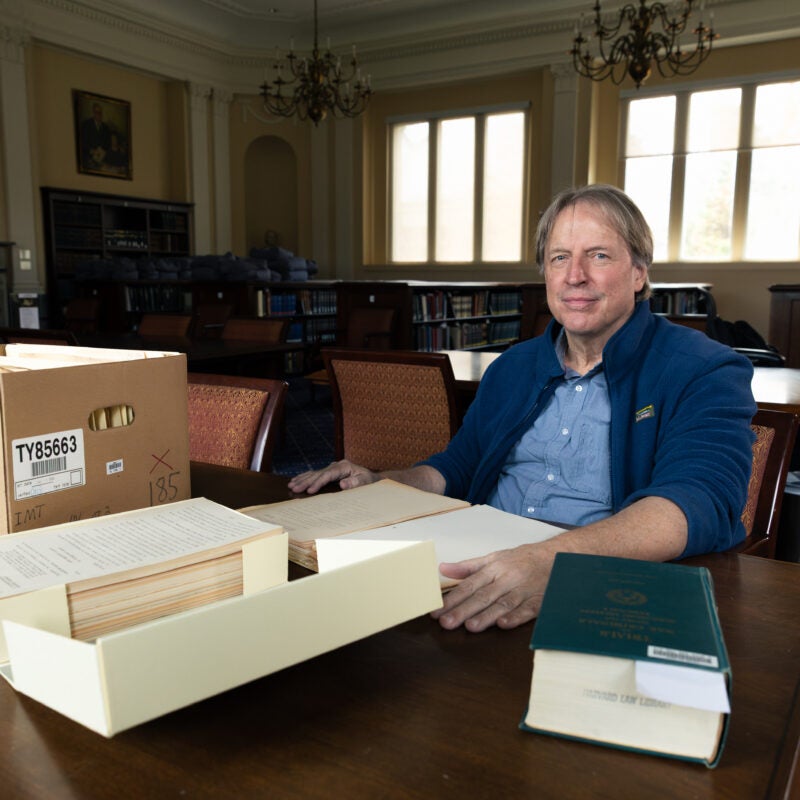 Paul Deschner at a table with Nuremberg files.