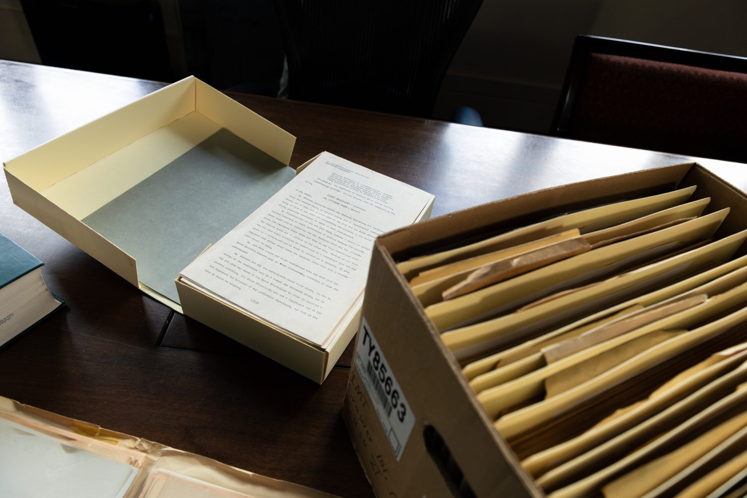 Box of paper transcripts from Nuremberg trials.