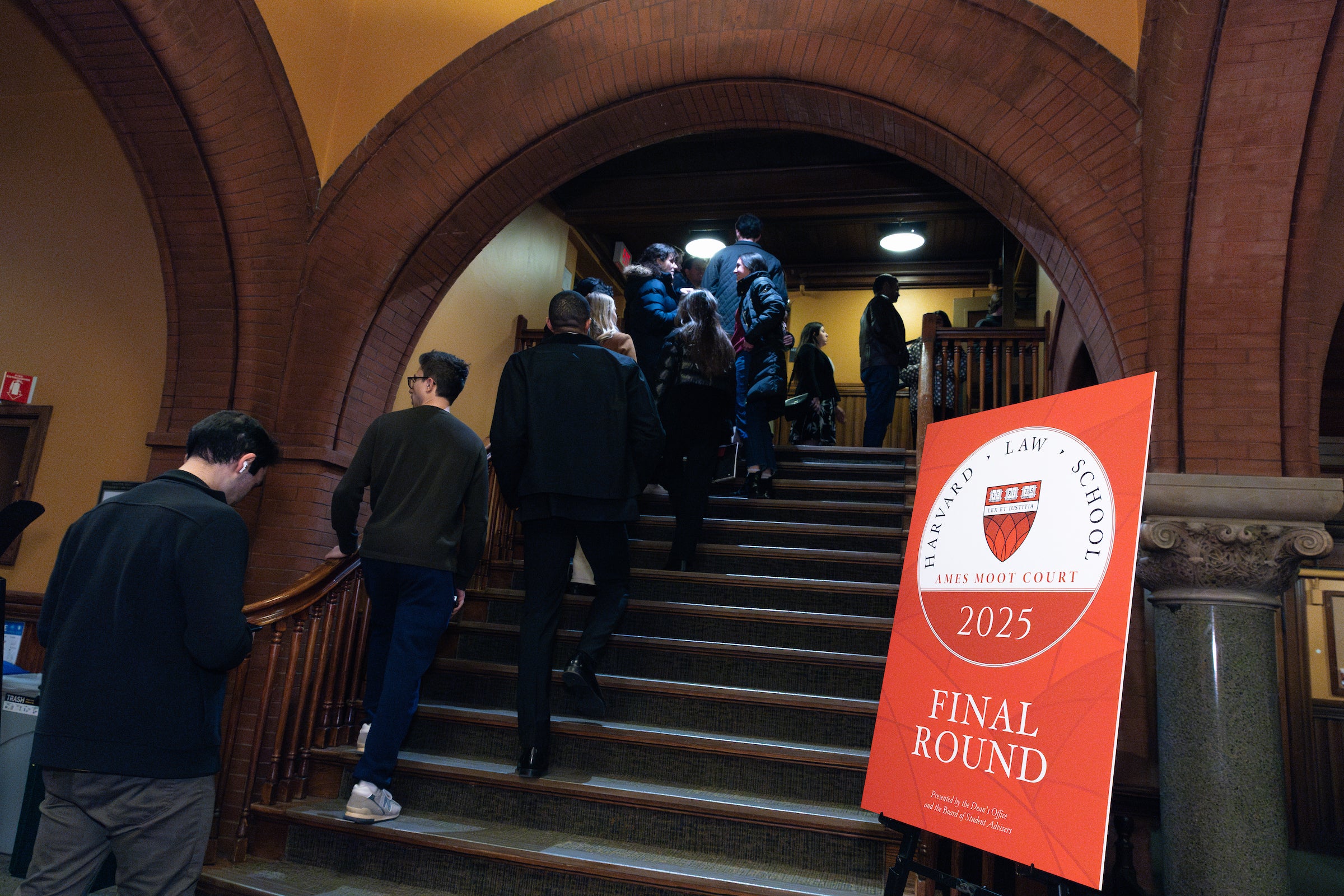 People walking up a set of stairs heading to an event