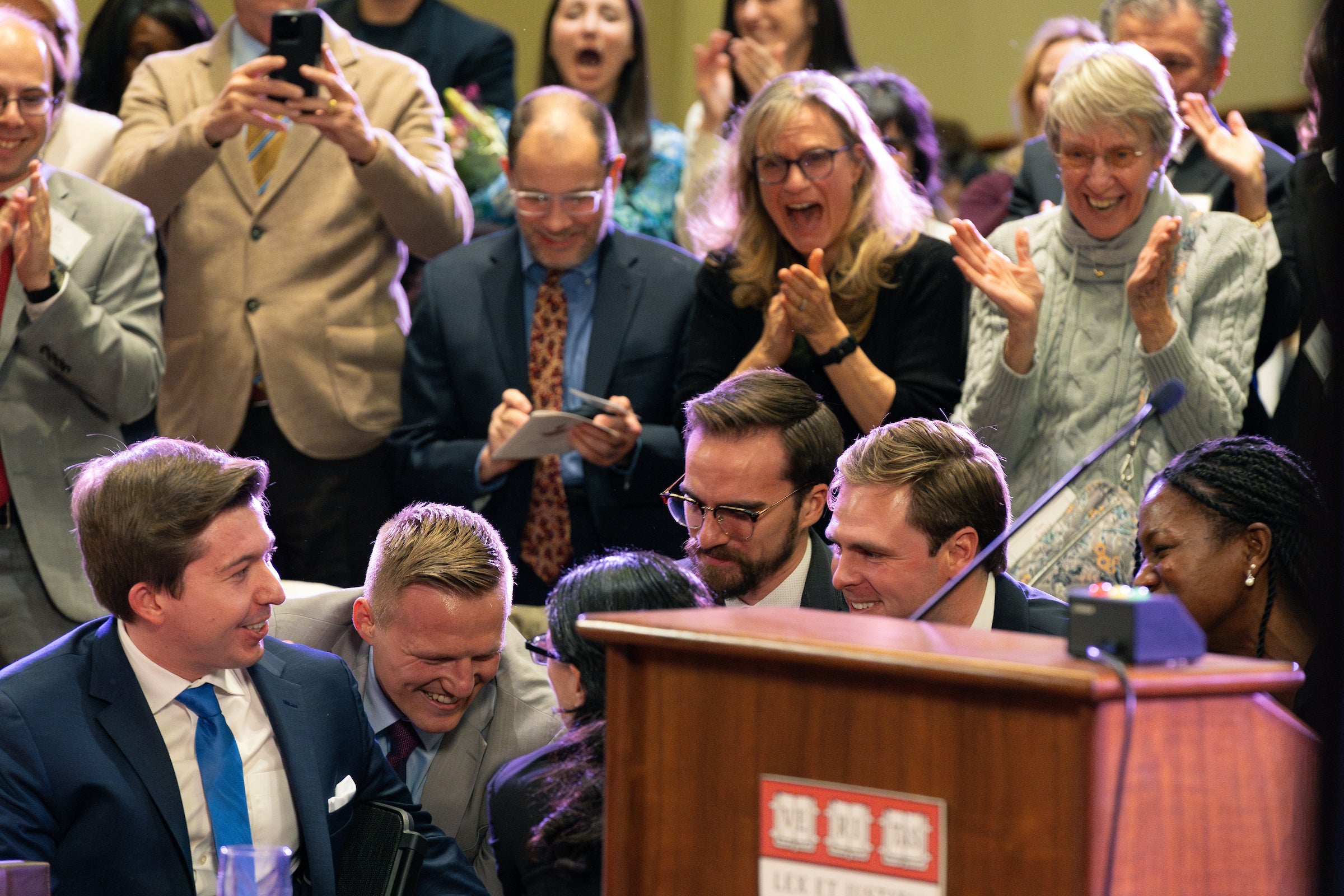 Team members clap as the team receives recognition from the judges.
