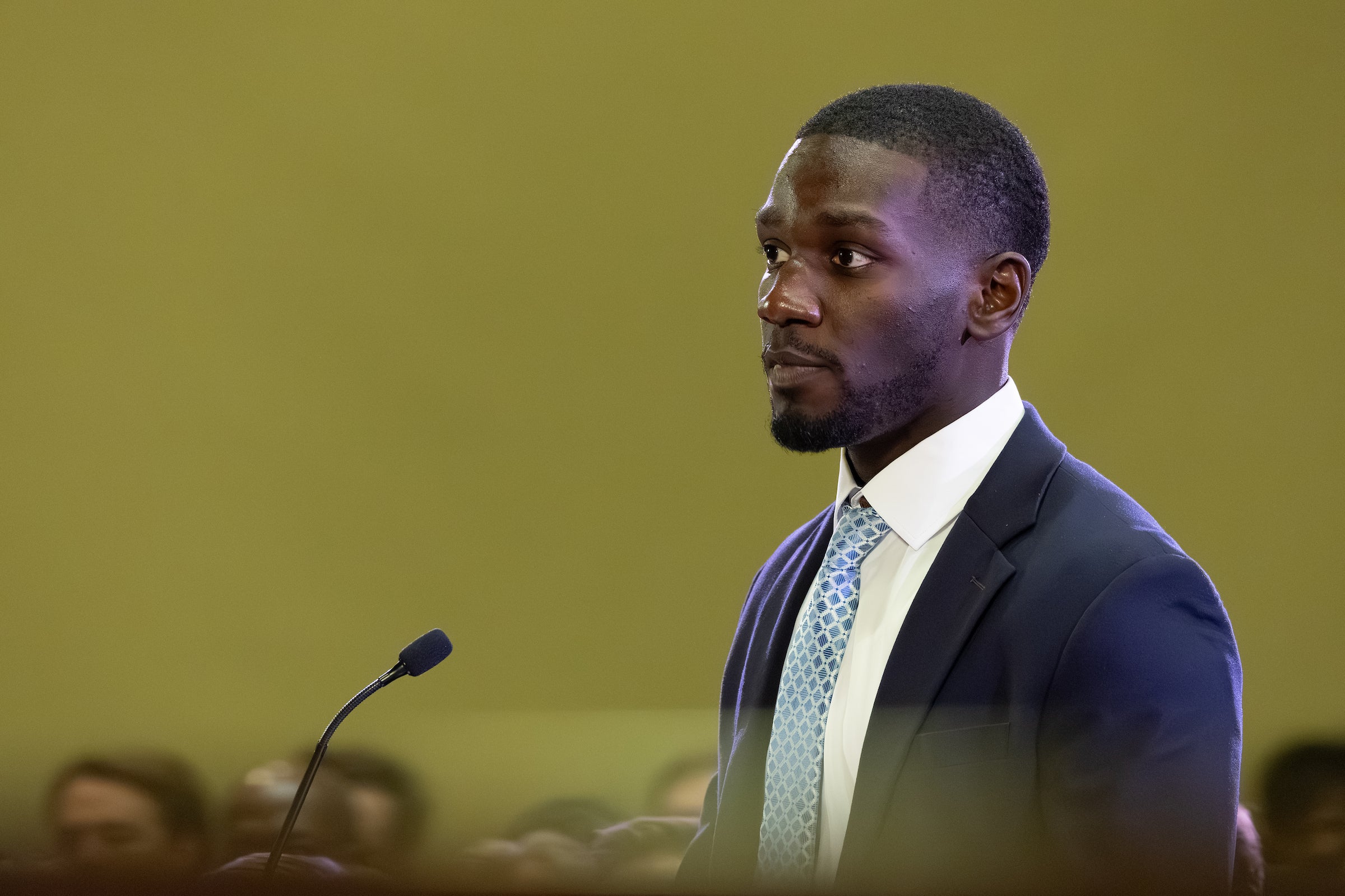 A man speaks at a podium.