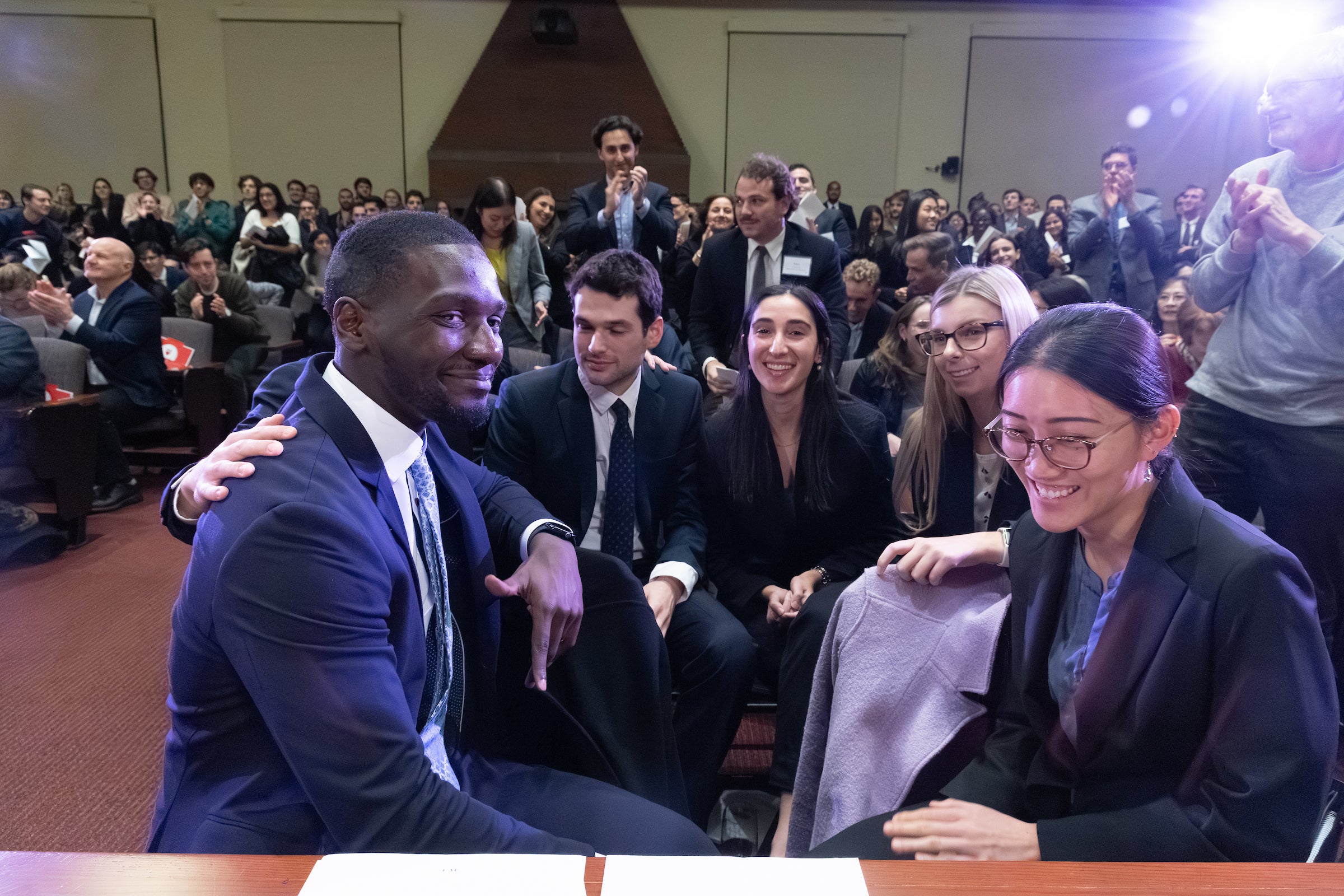 A group of students share excitement at the completion of oral arguments.