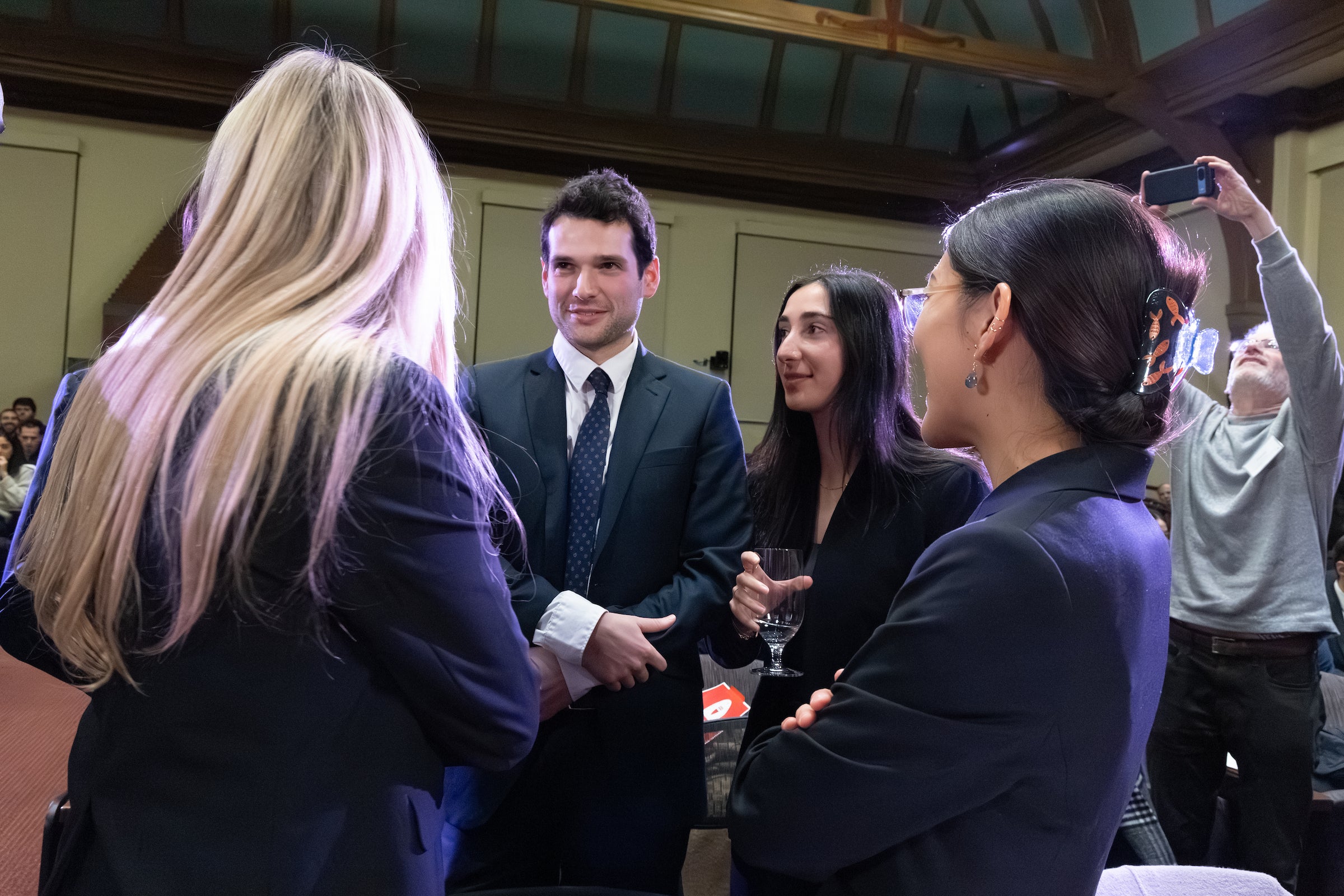 Team members gather together to share a happy moment.