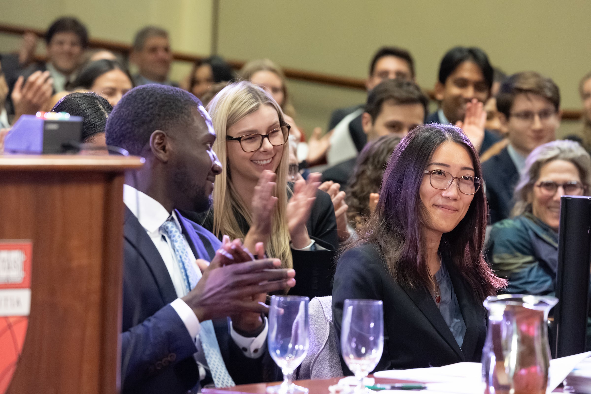 An oralist surrounded by her team responds to the news that she has won best oralist.