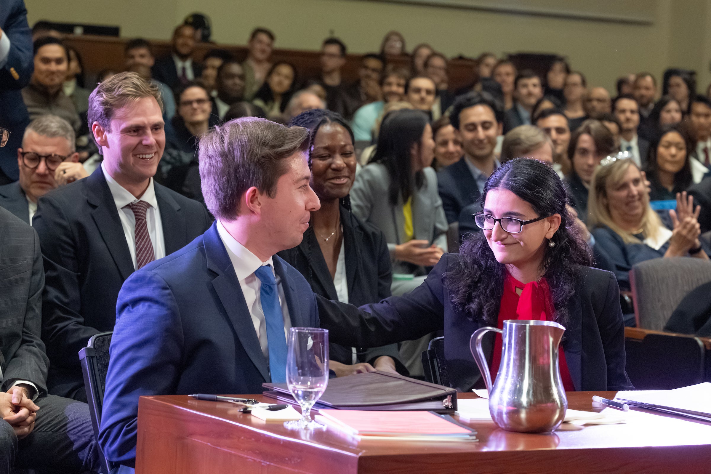 Oralists sitting at a table share a happy moment.