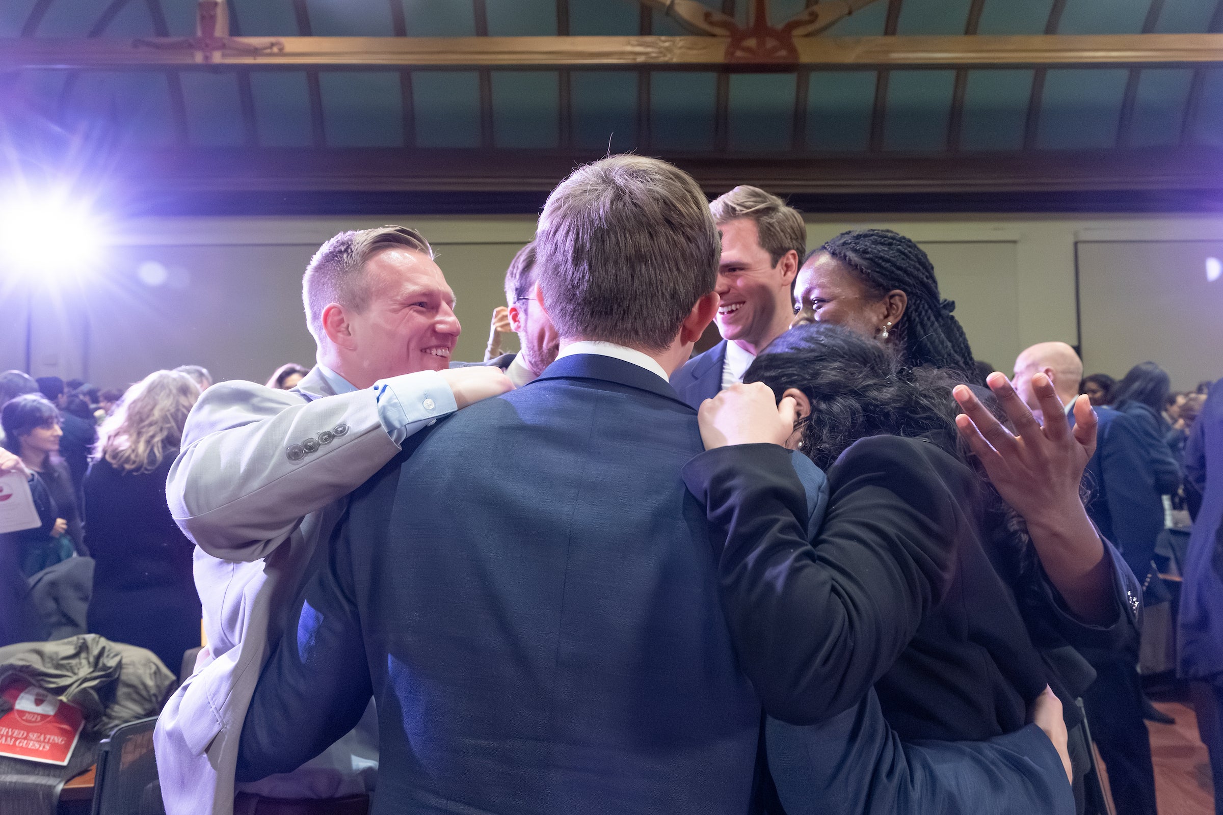 Team members gather for a group hug to celebrate.
