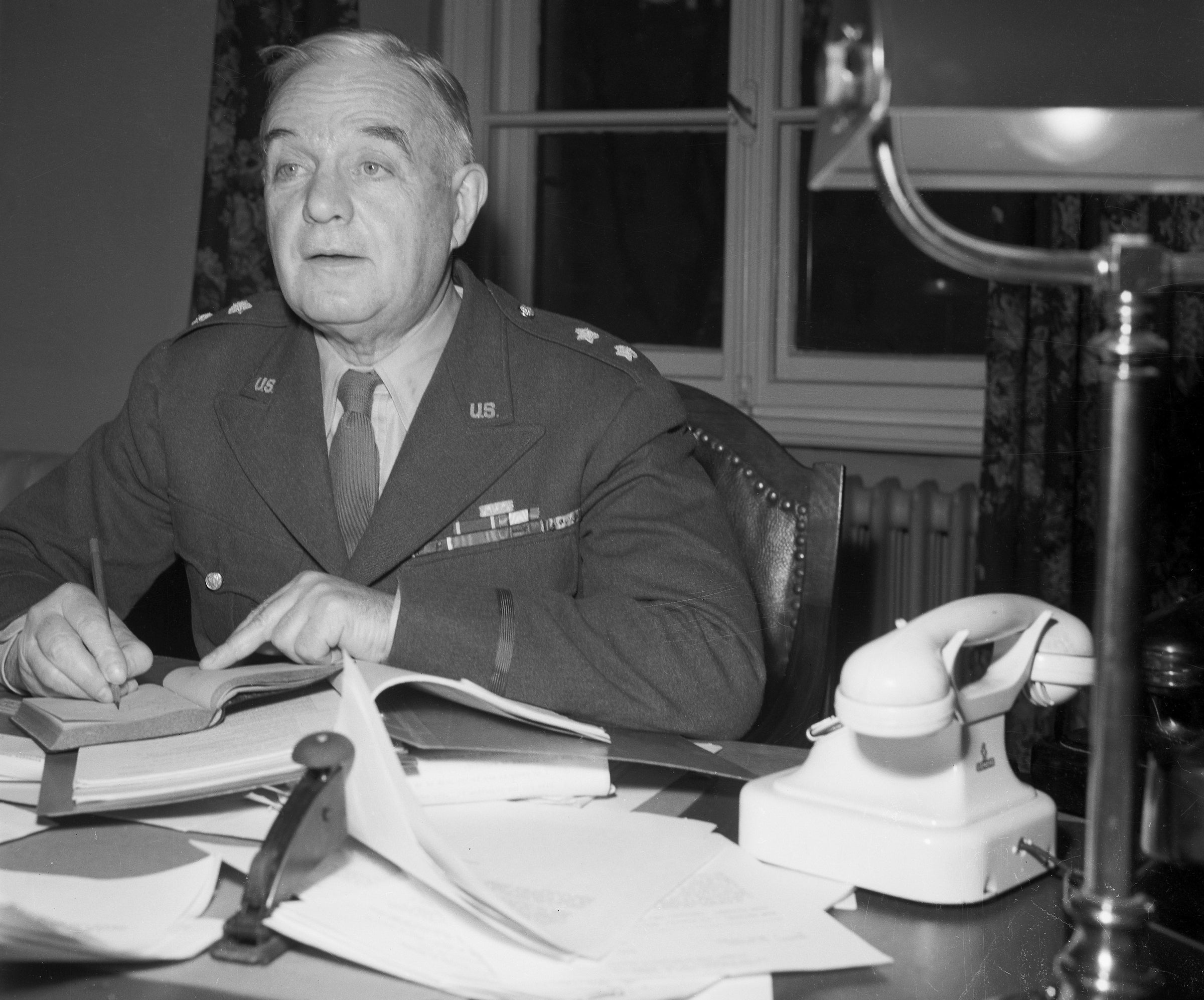 Major General William J. Donovan at his desk during the Nuremberg Trials.