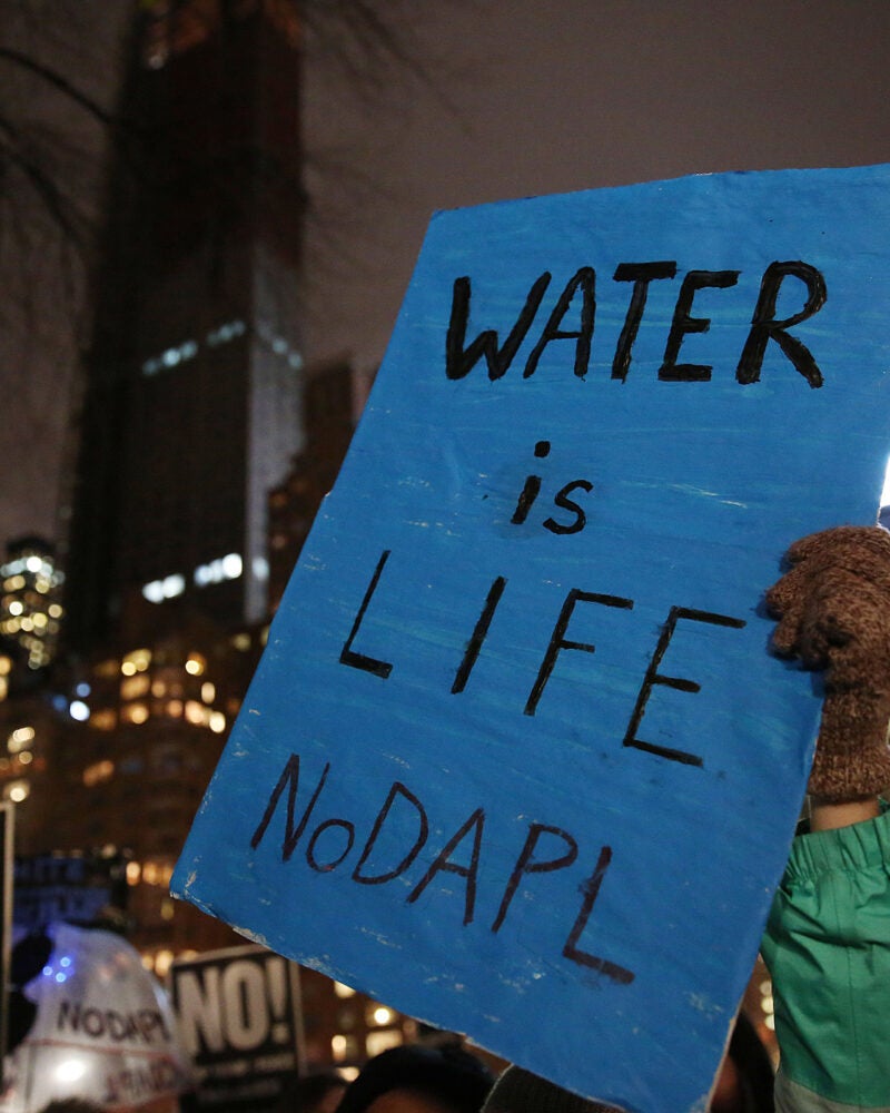 Blue protest sign reading 