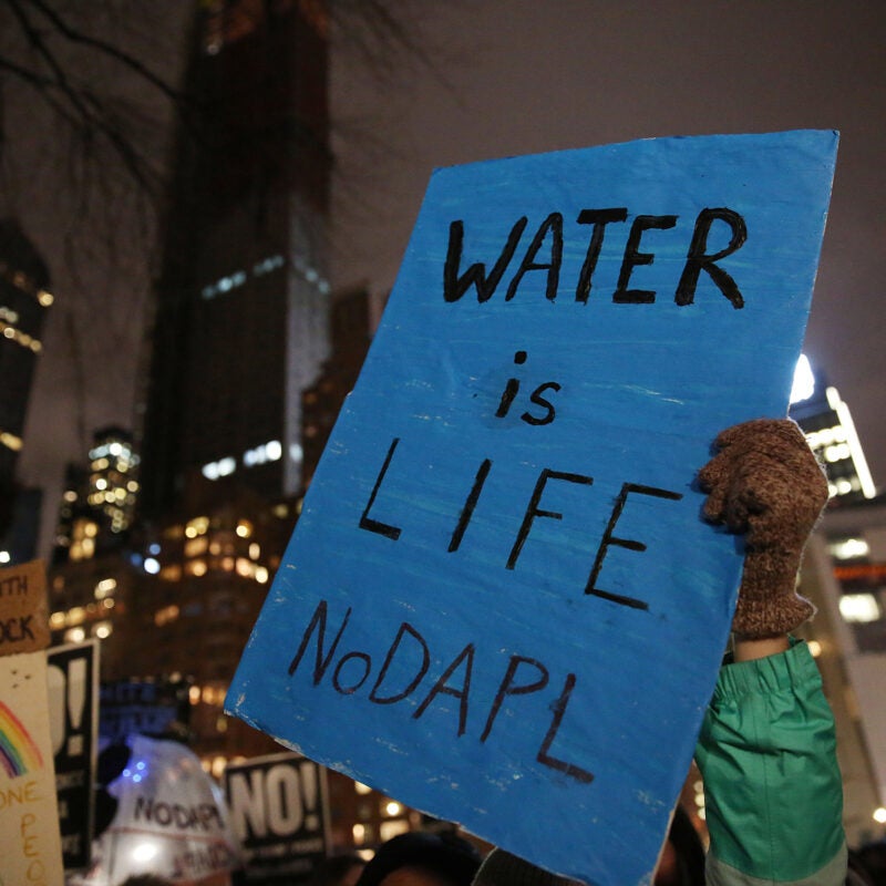 Blue protest sign reading 