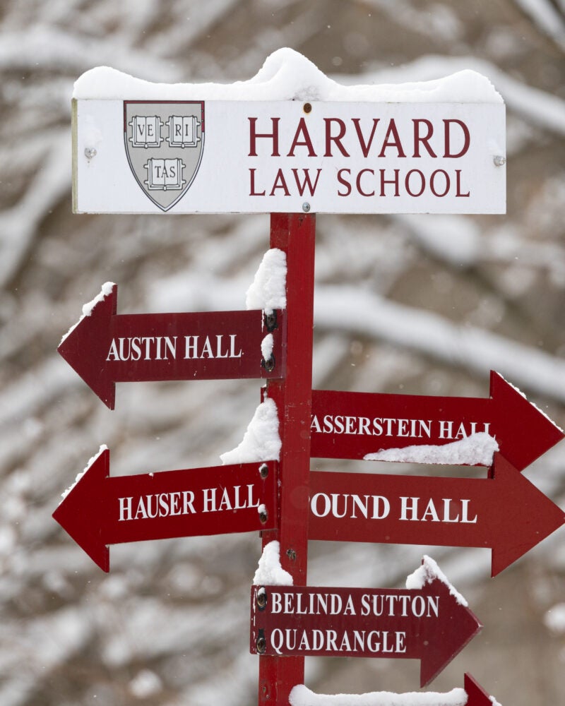 Directional sign of HLS buildings covered in snow