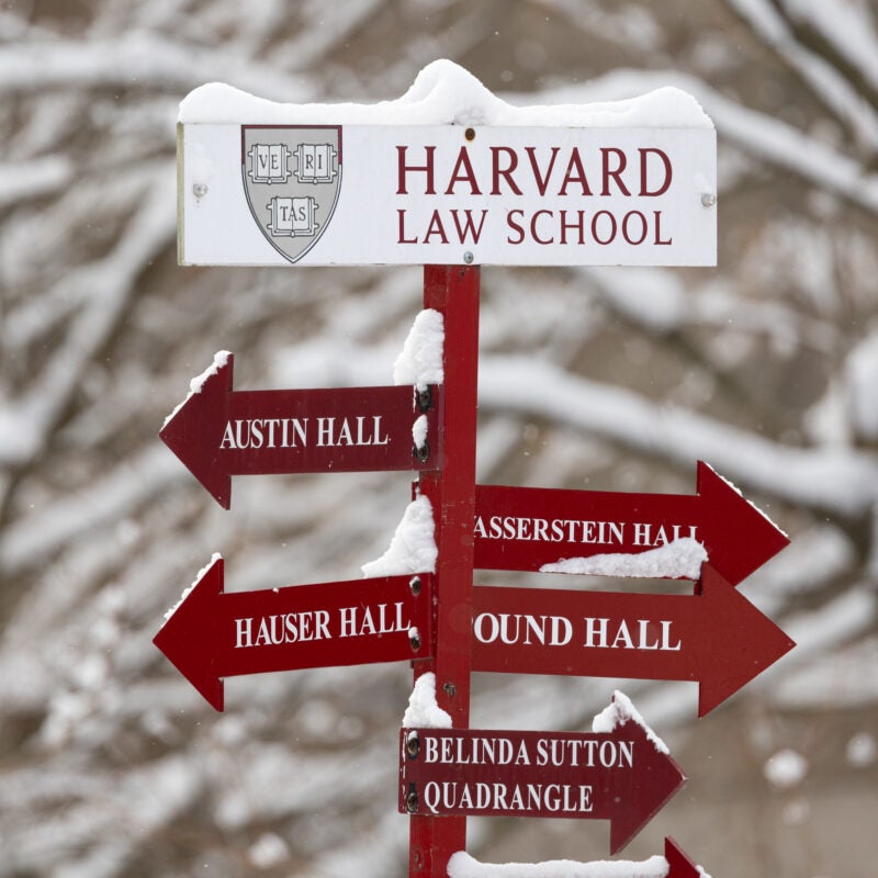 Directional sign of HLS buildings covered in snow