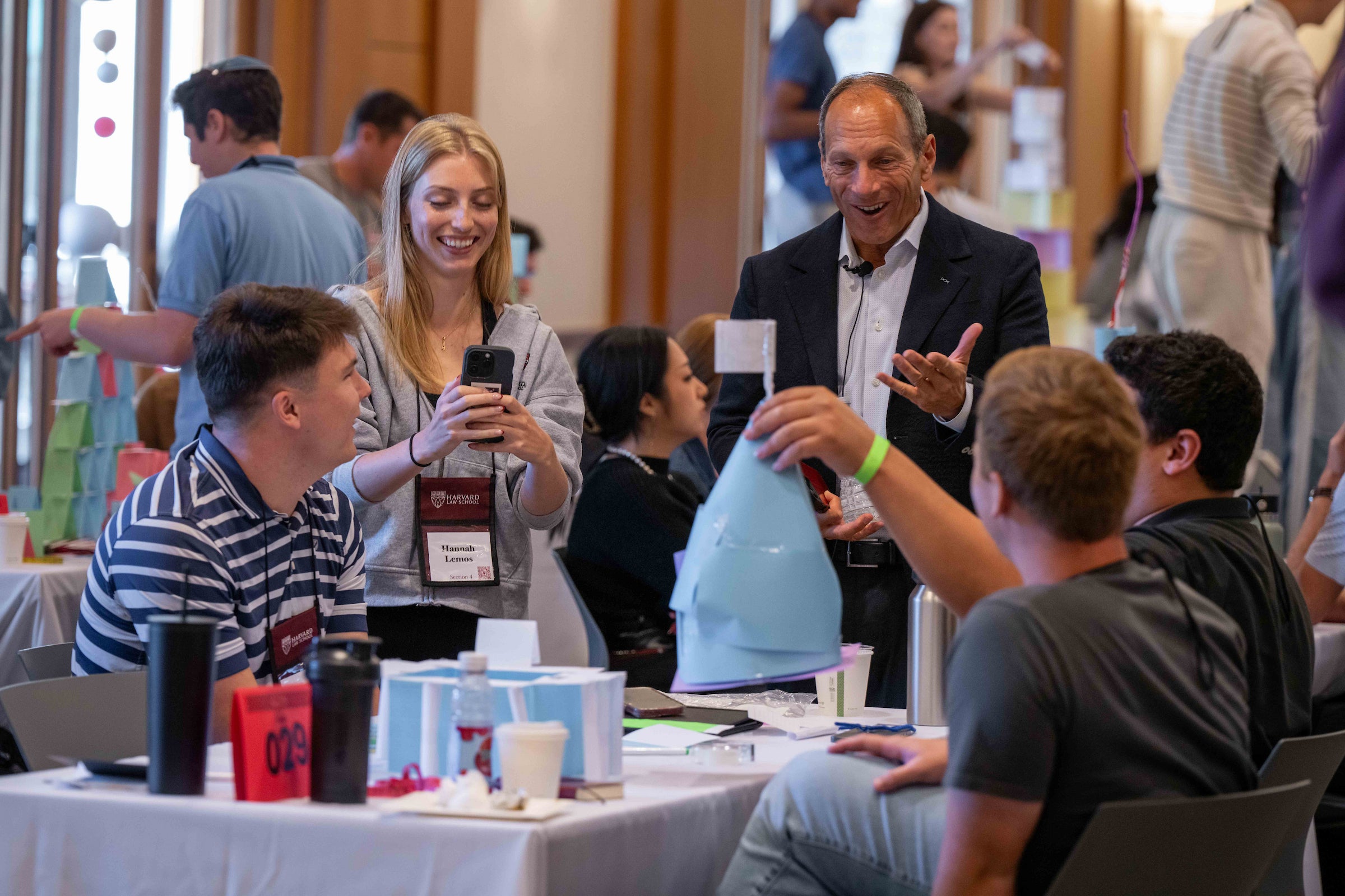 Professor Westfahl looks at paper structures being created as part of an orientation activity.