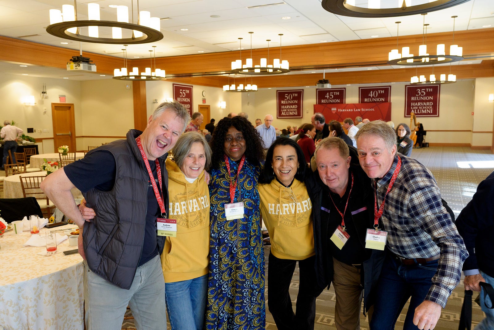 A group of alumni post for photo.