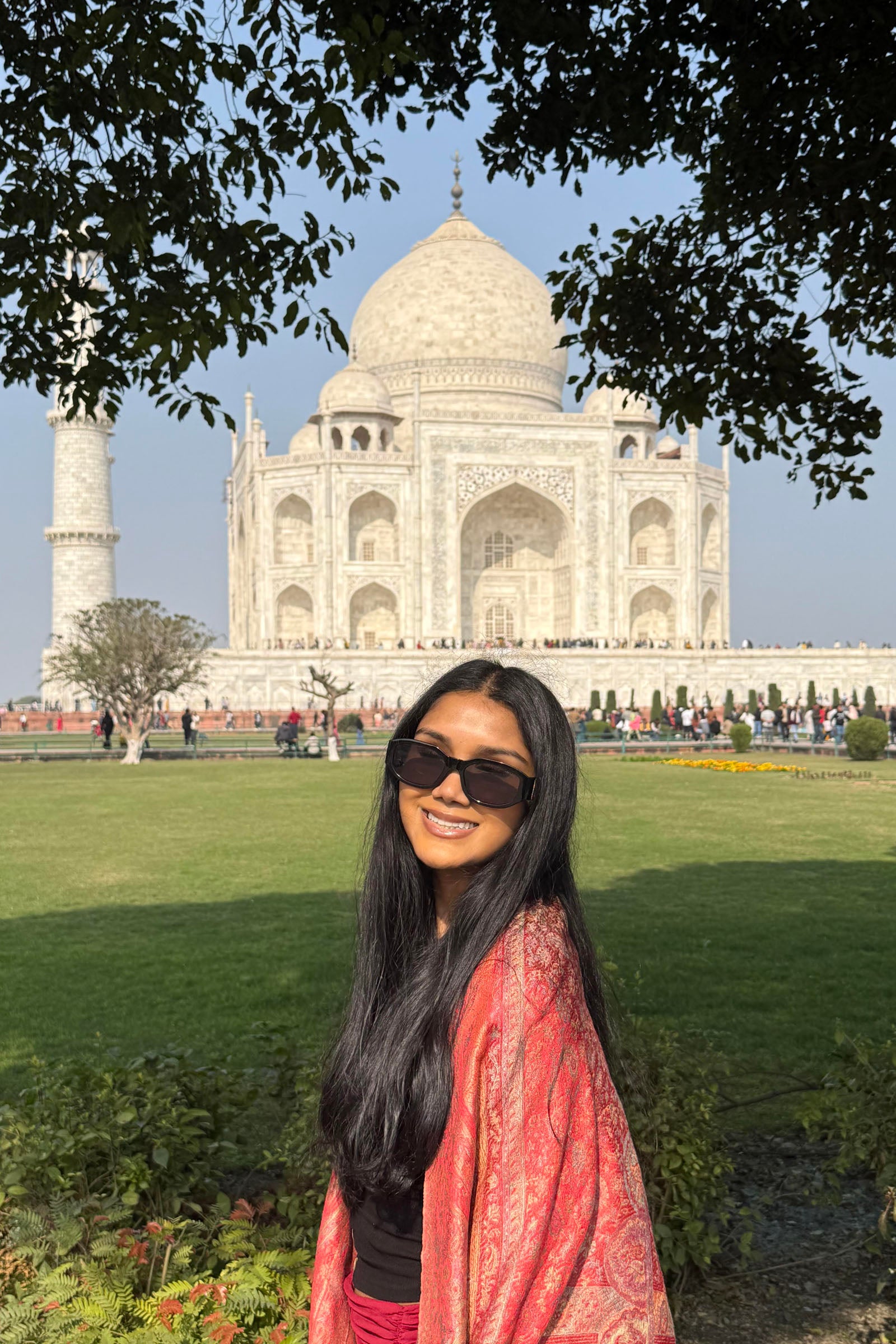 Uma Nambiar poses for a photo with the Taj Mahal in the background.